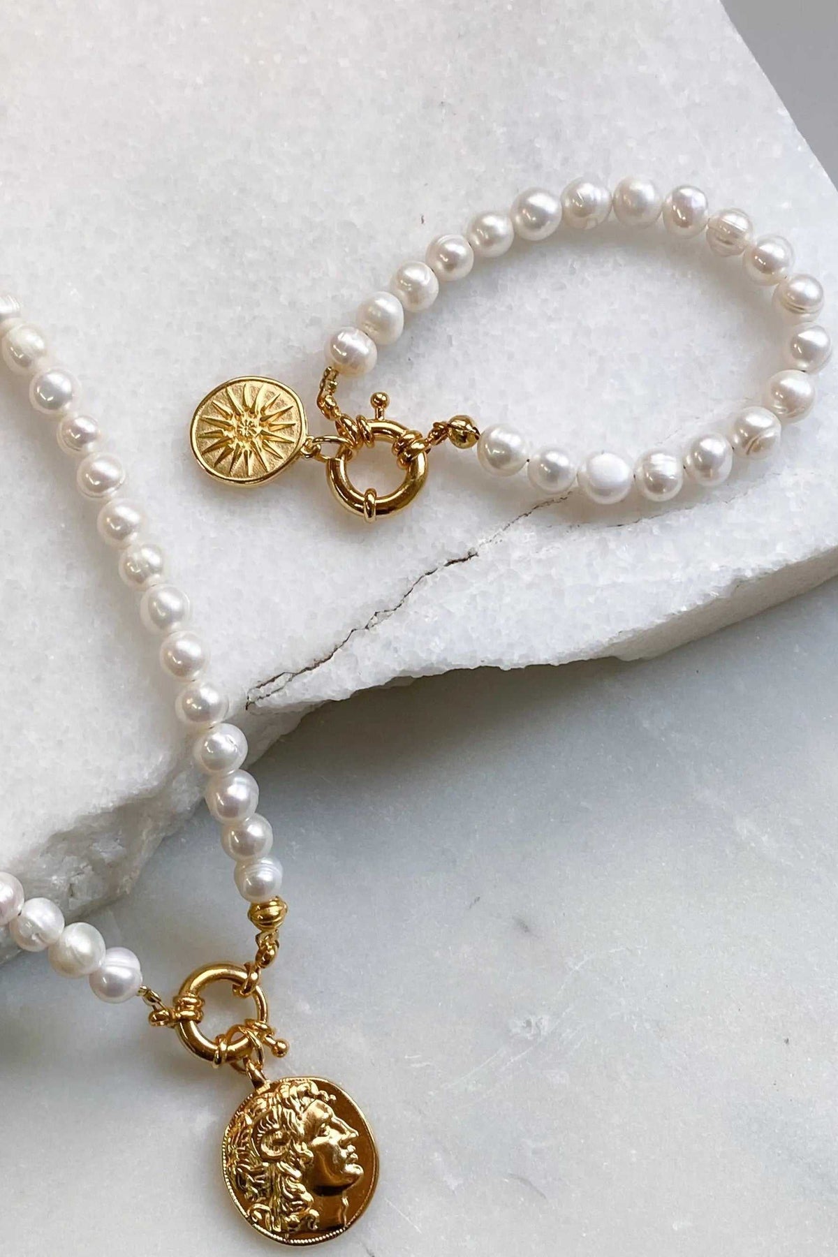 Alexander the Great pearl bracelet with glossy white freshwater pearls, gold-tone clasps and detailed ancient coin charms