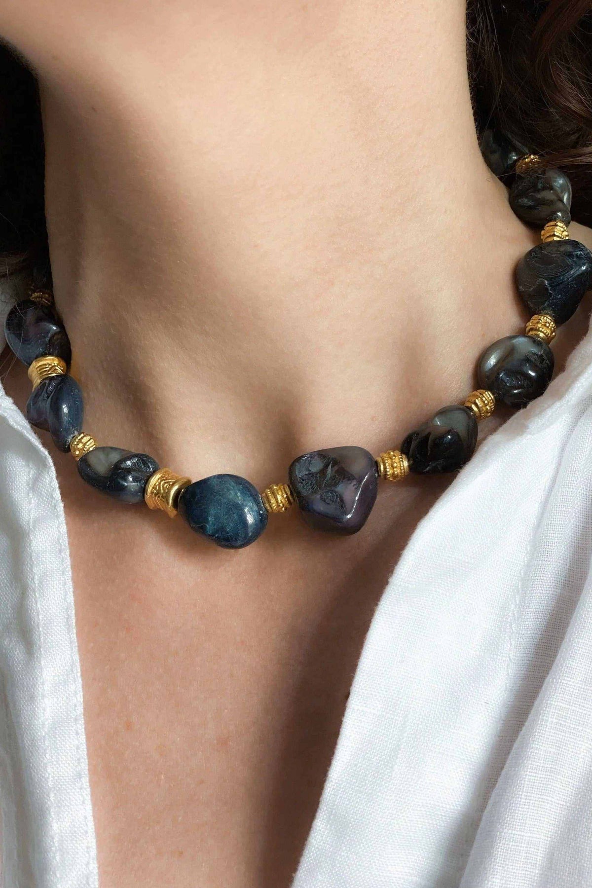 AMAZONA Shell Necklace with dark blue and black polished beads, gold-tone spacers, and varied rounded shapes