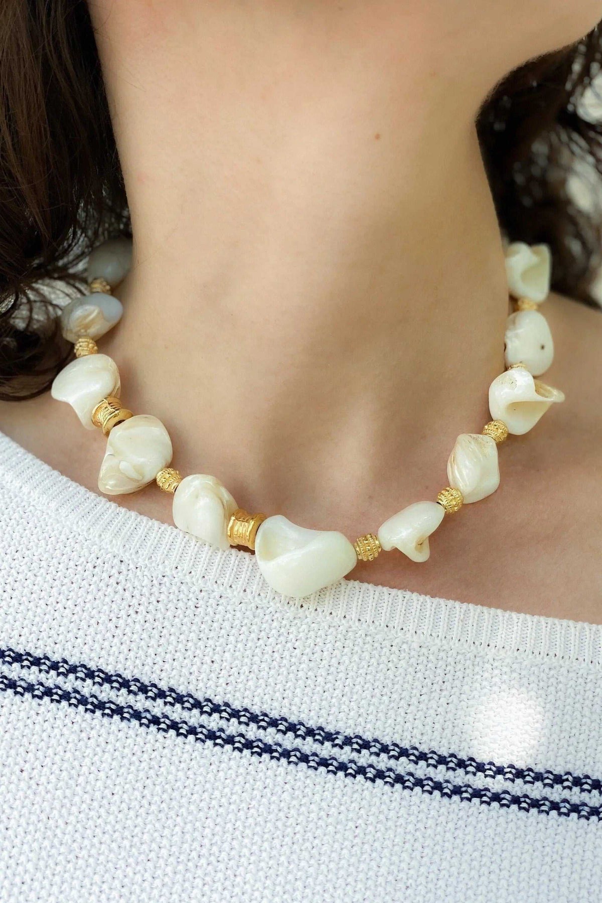 AMAZONA Shell Necklace with natural white shell beads, gold-toned accents, and a large central shell pendant