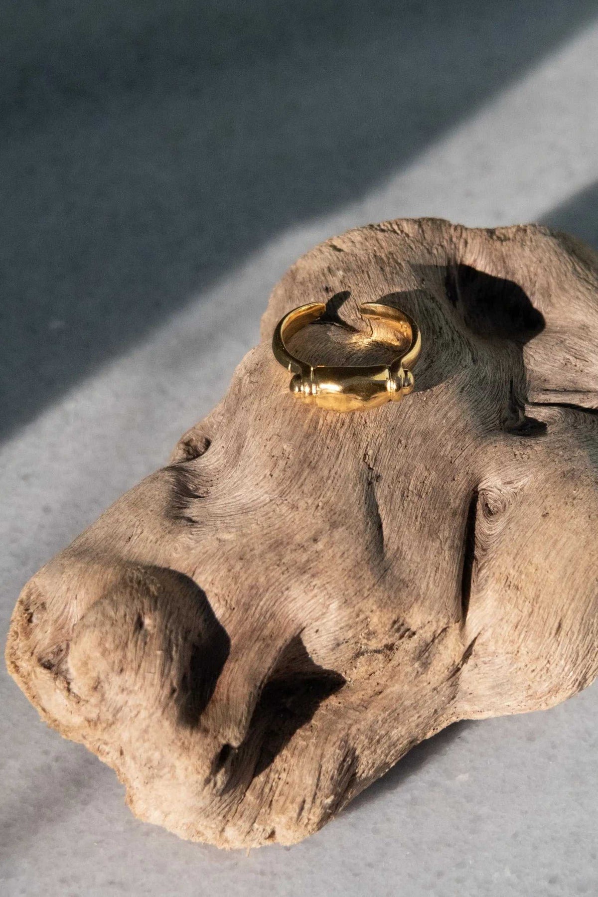 Ancient Greek ring in gold tone with a sculpted bull motif and textured band, featuring an open adjustable design.