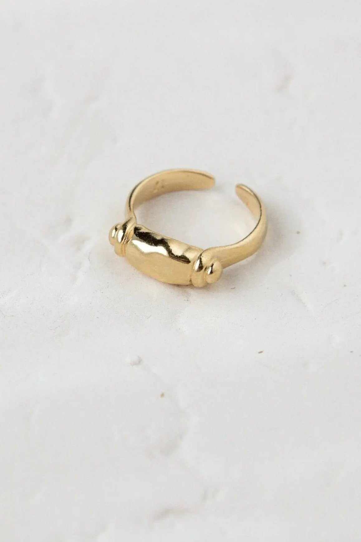 Ancient Greek ring in gold-tone metal with a smooth open adjustable band and sculpted bar detail with rounded ends