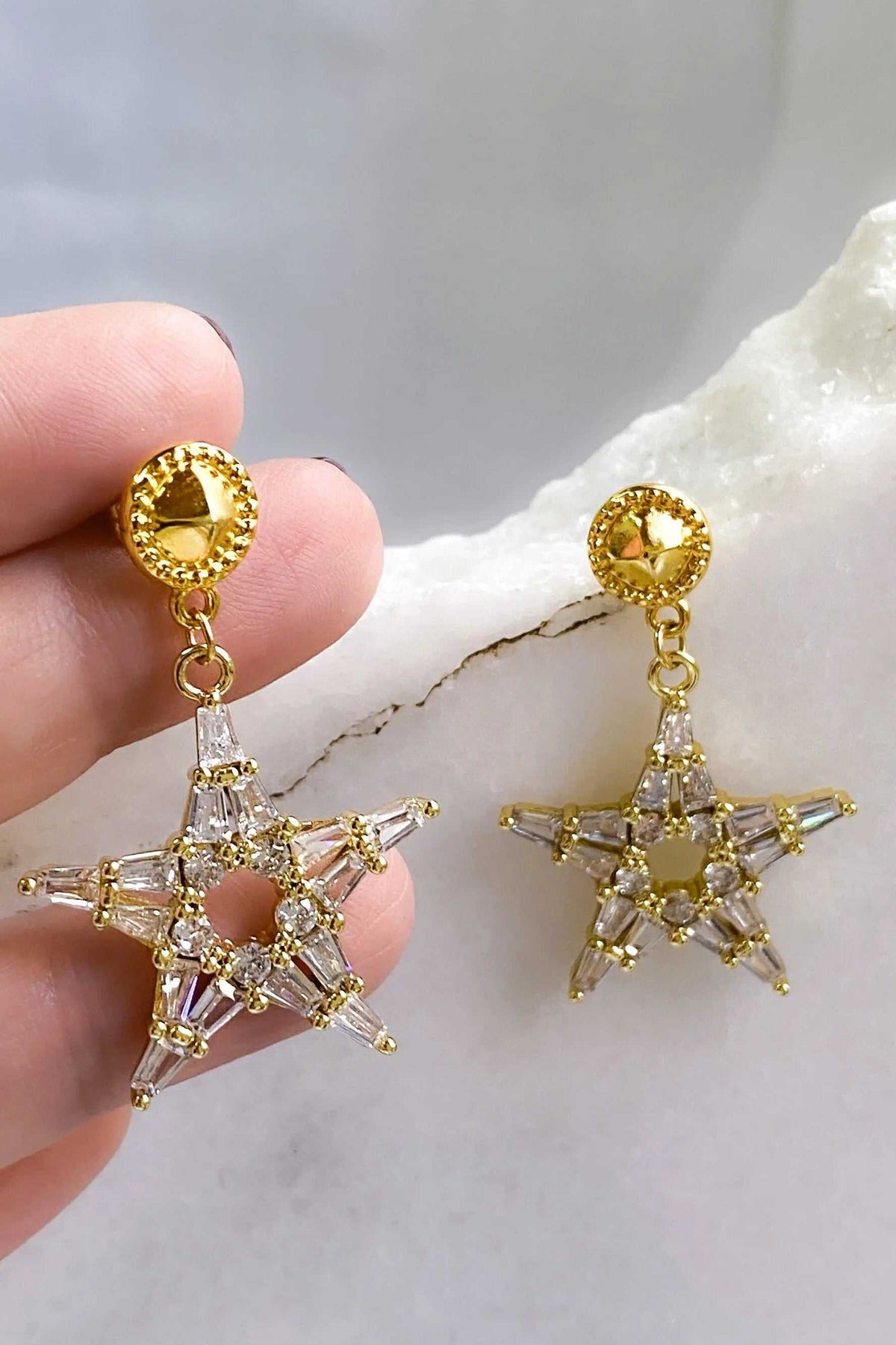 ANDROMEDA Earrings with gold-tone circular studs and dangling open star shapes set with clear and pale yellow stones