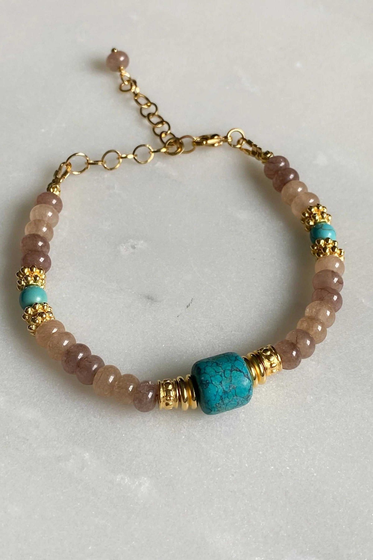 ARETI Bracelet with translucent beige agate beads, turquoise stone accents, gold-toned decorative spacers and extender chain