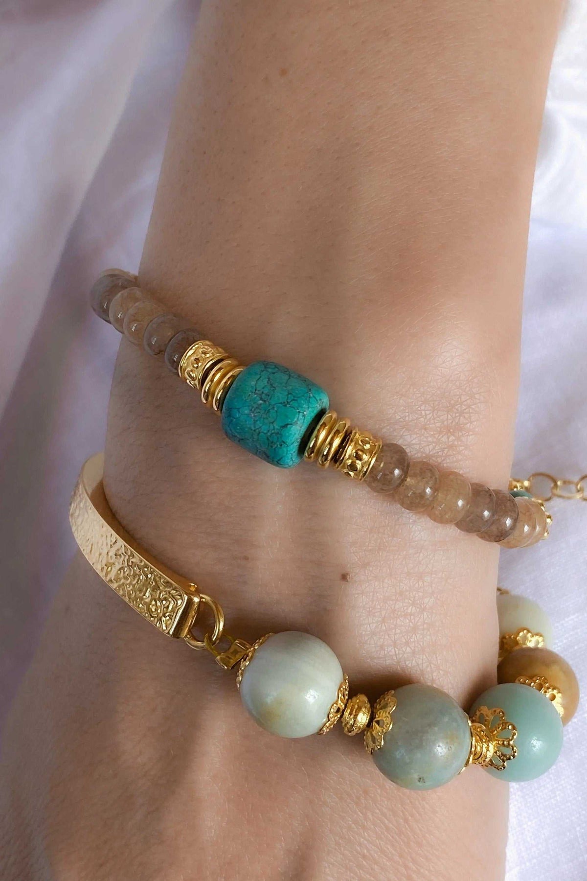 ARETI Bracelet with translucent agate beads, a vivid turquoise stone, and ornate gold-tone spacer details