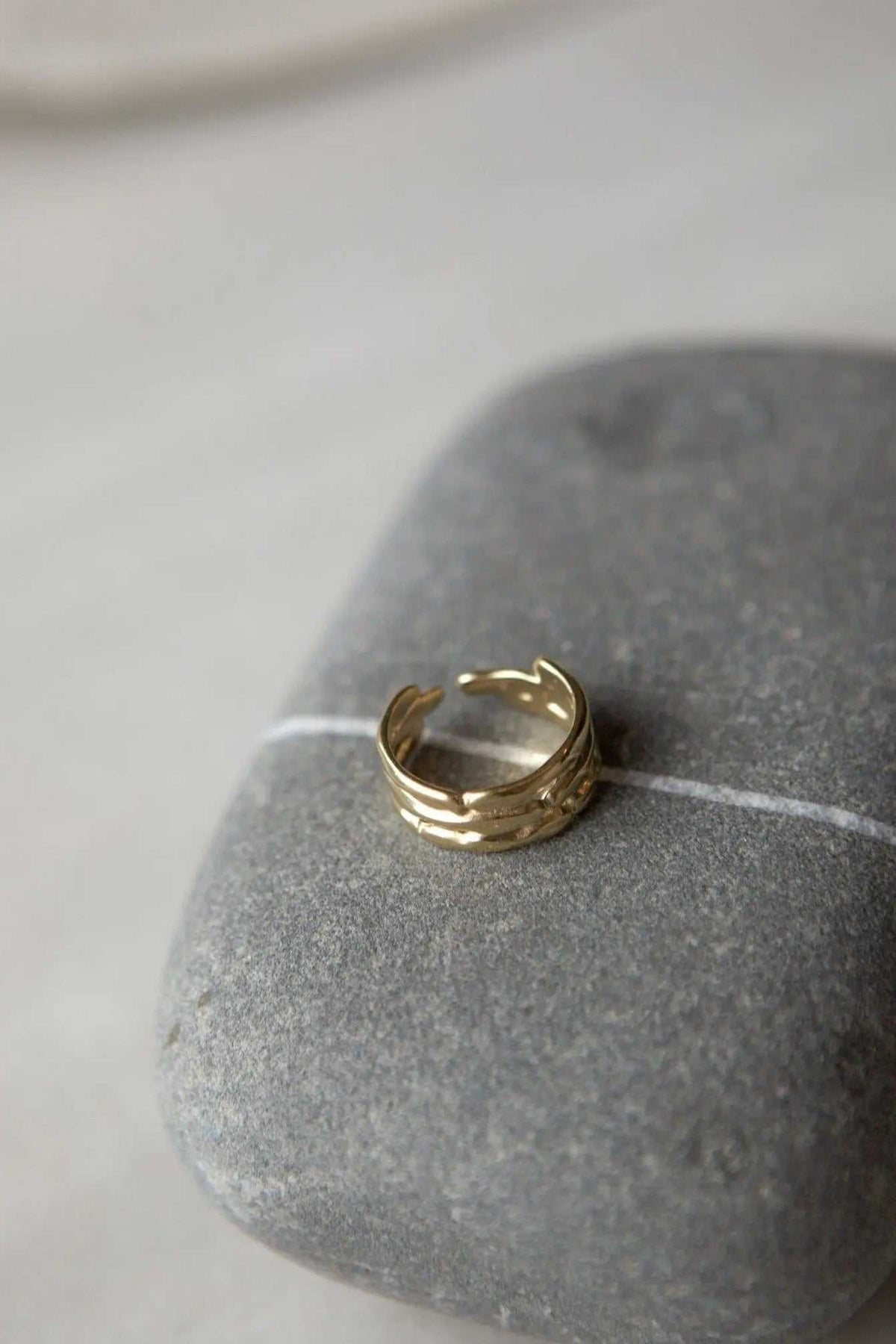 Bamboo pattern RING in gold-tone metal with a polished finish, open adjustable band and raised bamboo-like ridges