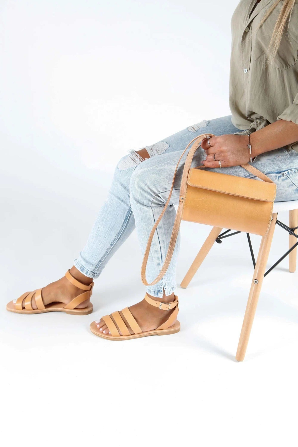 Barrel Bag in tan leather with a structured rectangular body, top flap, and long adjustable shoulder strap