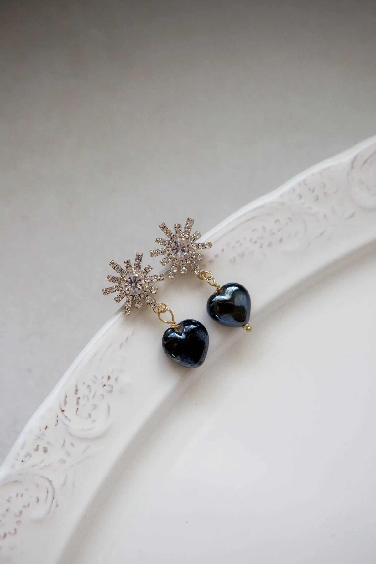 BLACK crystal Heart Earrings with glossy black heart charms and sparkling gold-tone starburst stud details