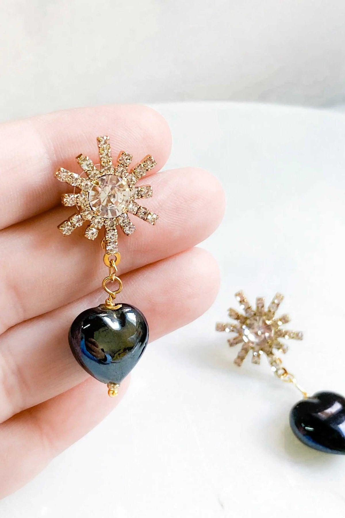 BLACK crystal Heart Earrings with glossy black heart drops and gold-toned crystal starburst tops