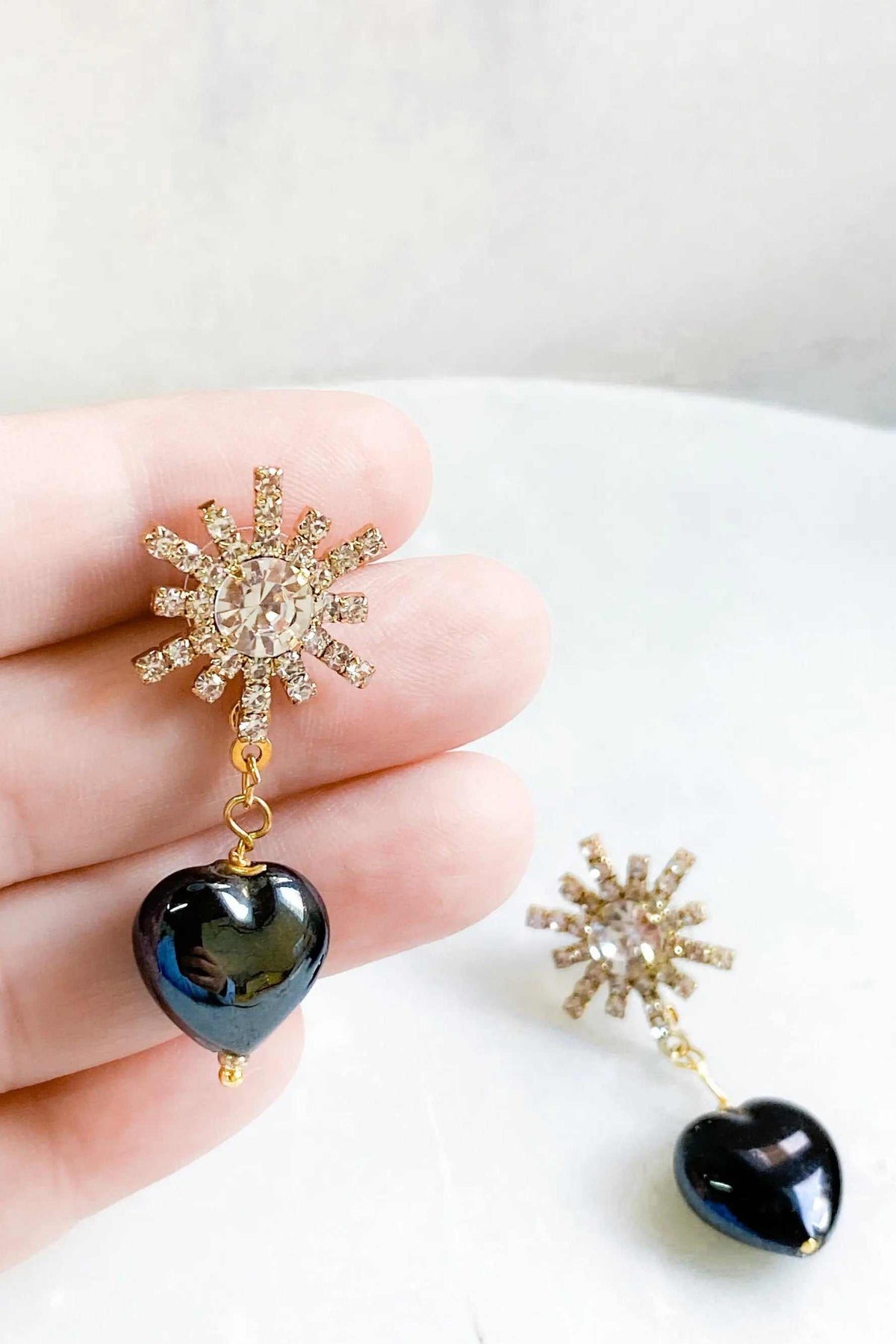 BLACK crystal Heart Earrings in black crystal with gold-toned starburst charms and heart-shaped drops