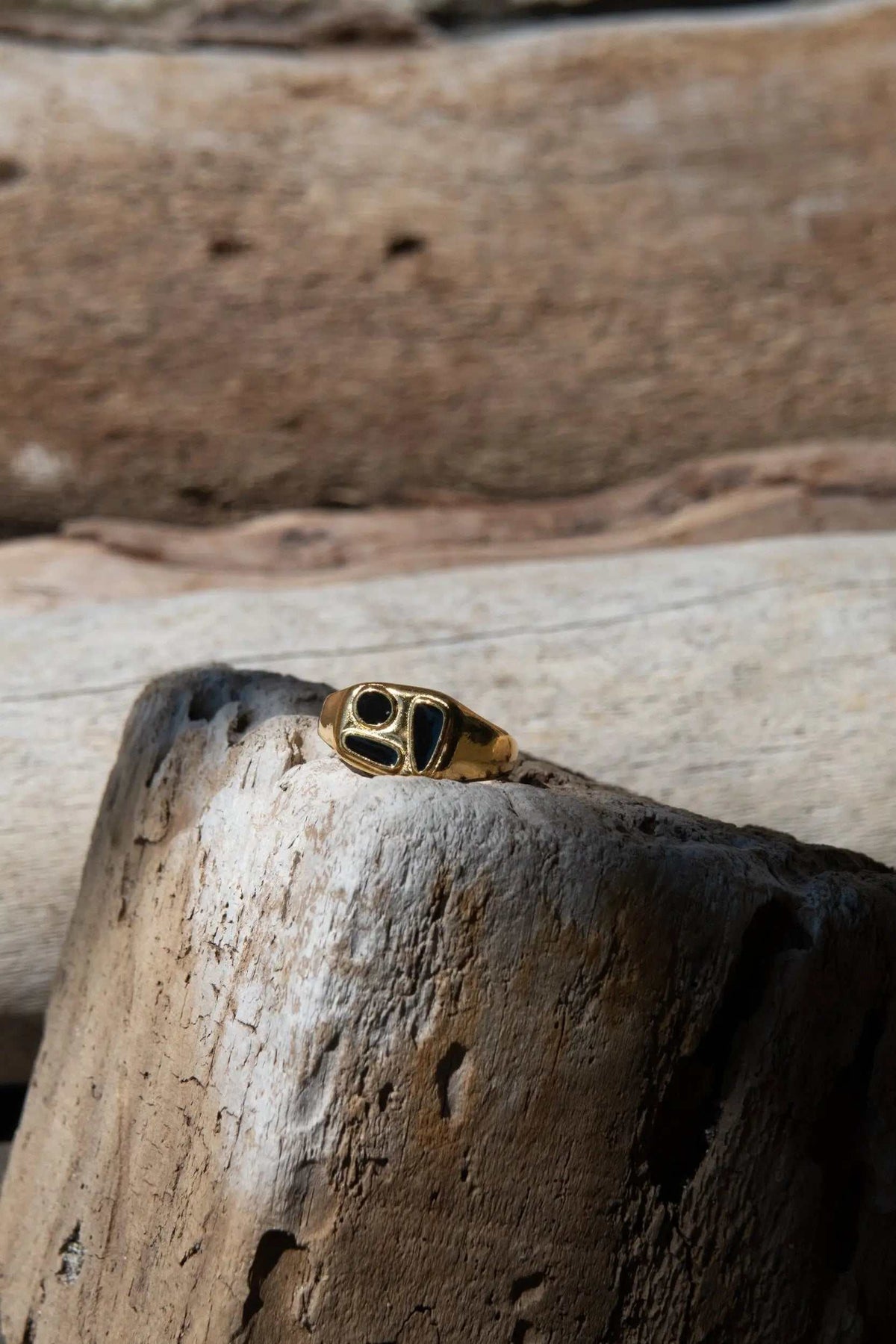 Black Forms Stamp RING, gold-tone adjustable band with a bold black geometric face and polished edges
