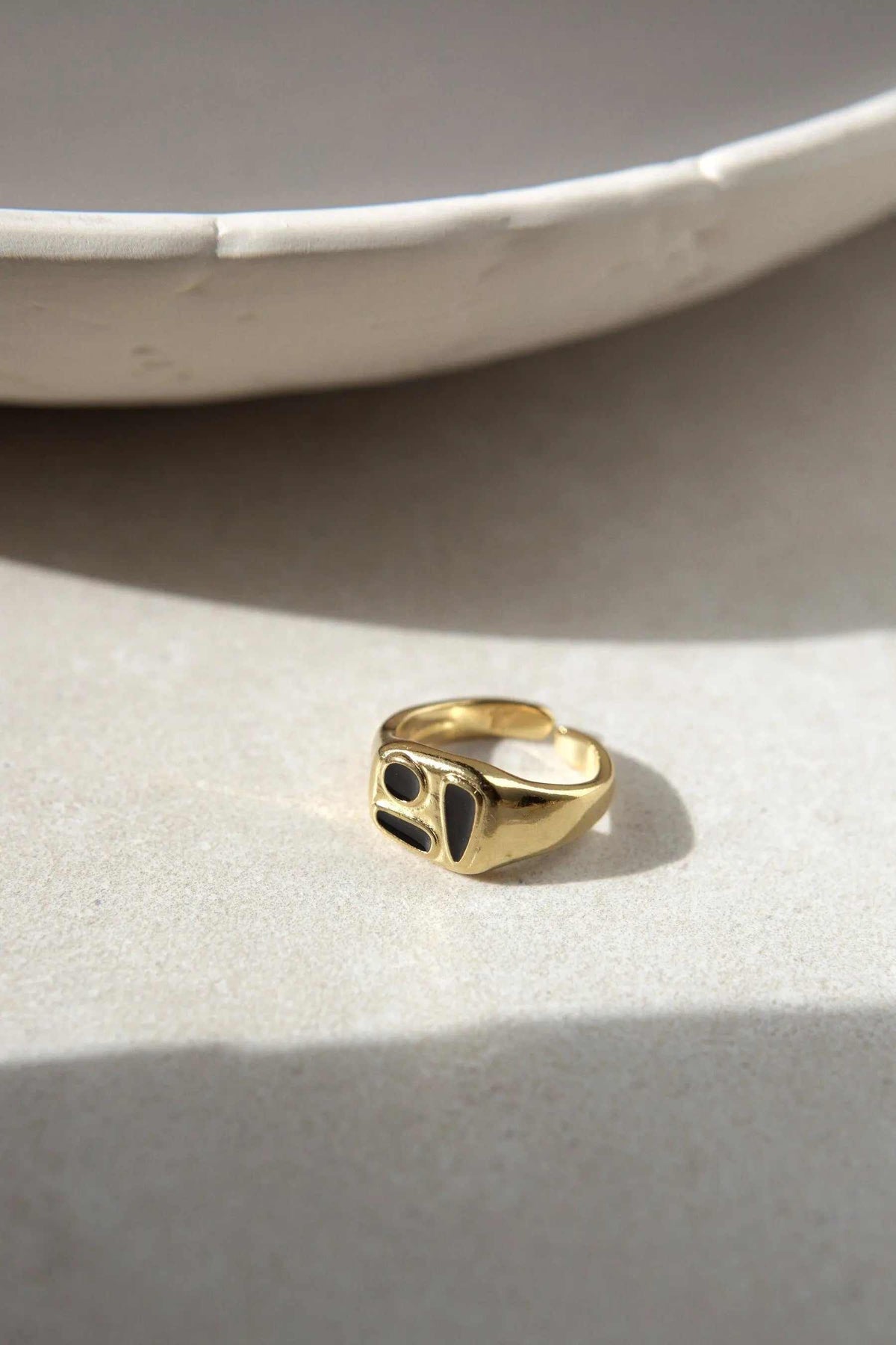 Black Forms Stamp RING in gold-tone metal, featuring a bold signet face with glossy black geometric inlays