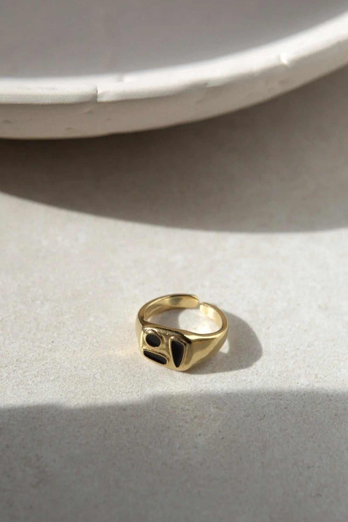 Black Forms Stamp RING in gold-tone metal with a bold sculptural face and two glossy black accents