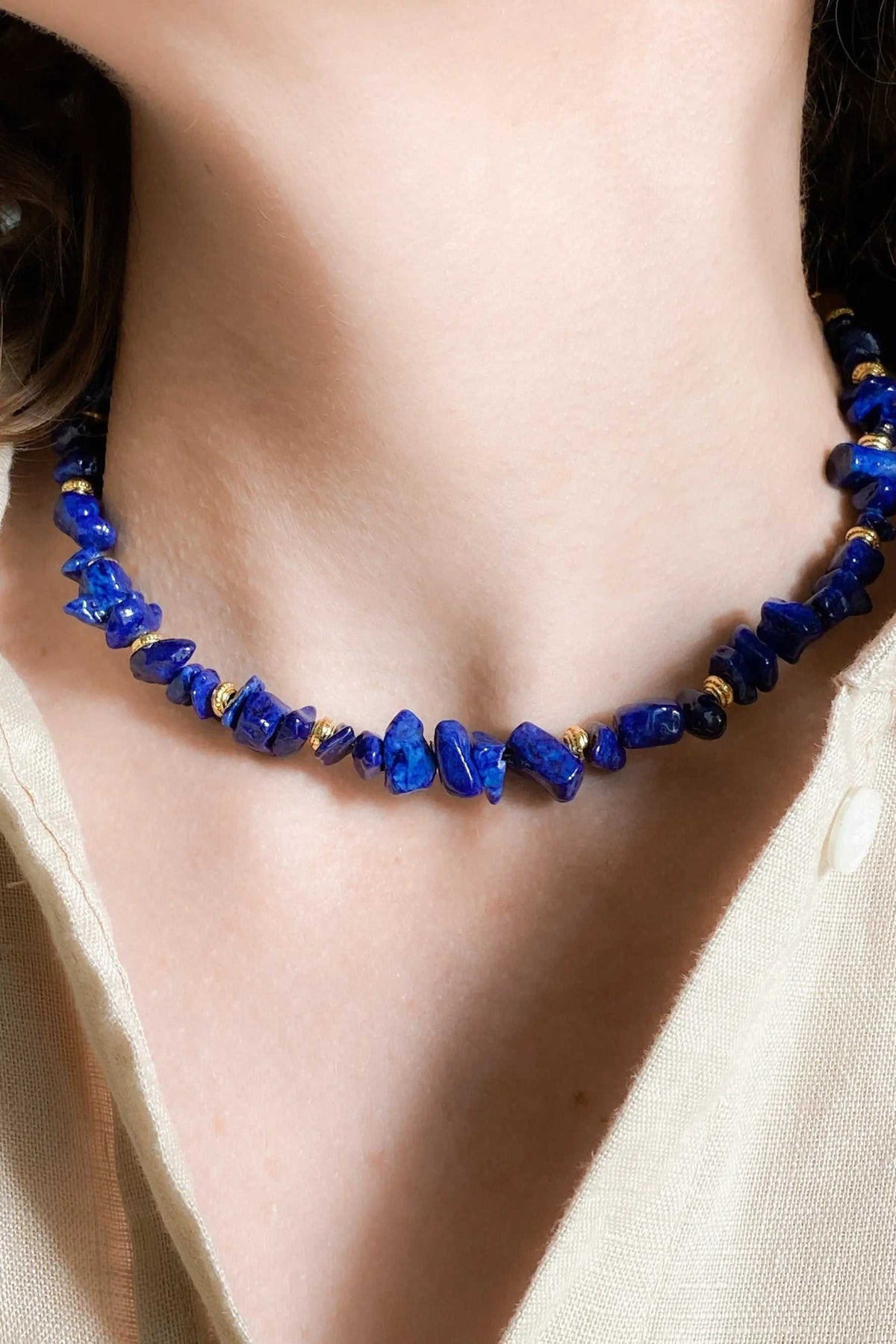 Blue Jade necklace featuring vivid blue irregular stone beads with small gold-toned spacer details