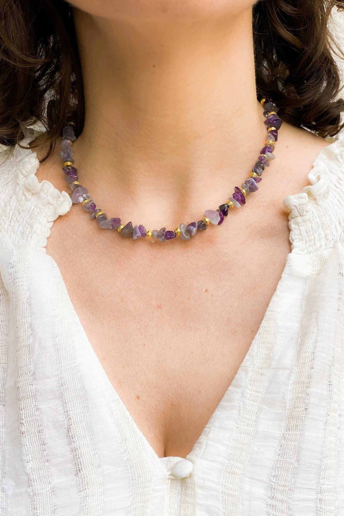 Blue Jade necklace featuring purple and blue natural stone beads with gold-toned accents in a short strand
