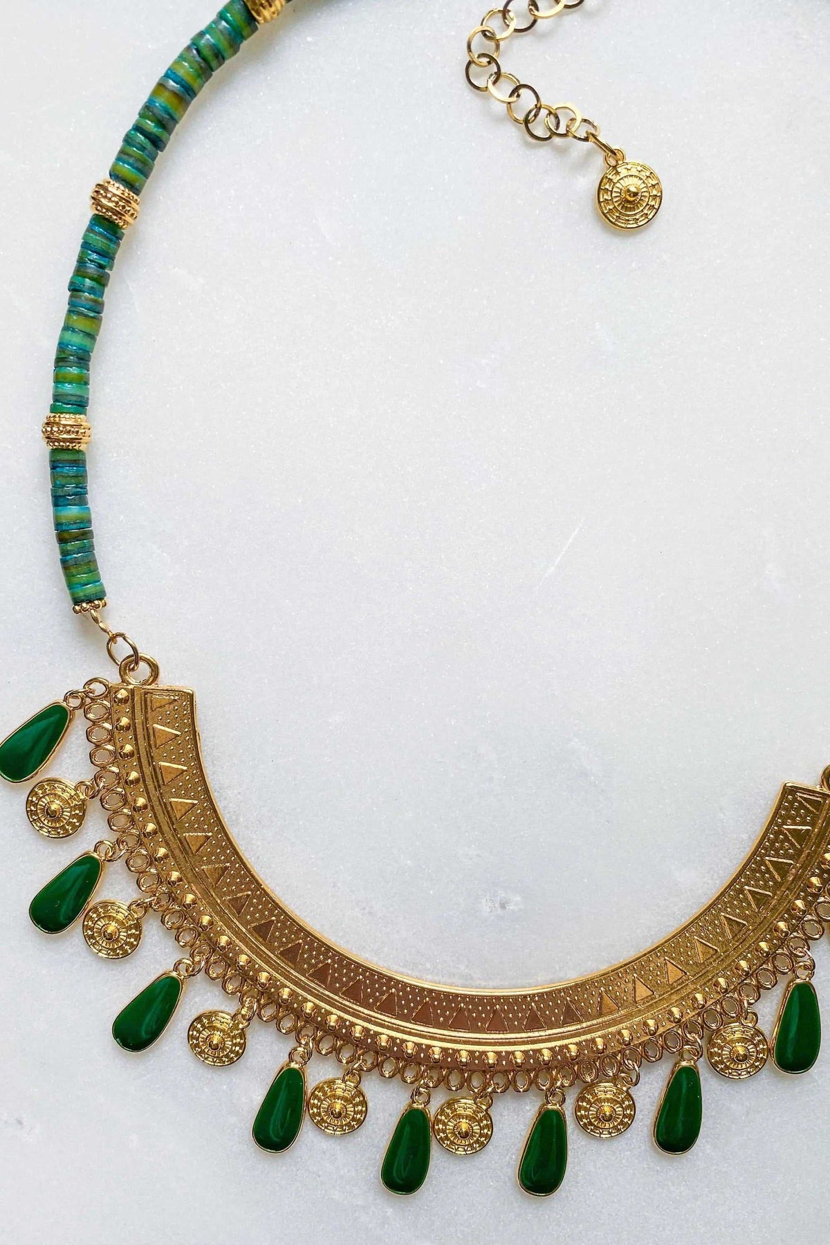 Boho chic necklace with a gold-tone engraved crescent pendant, green enamel teardrop charms and turquoise beads