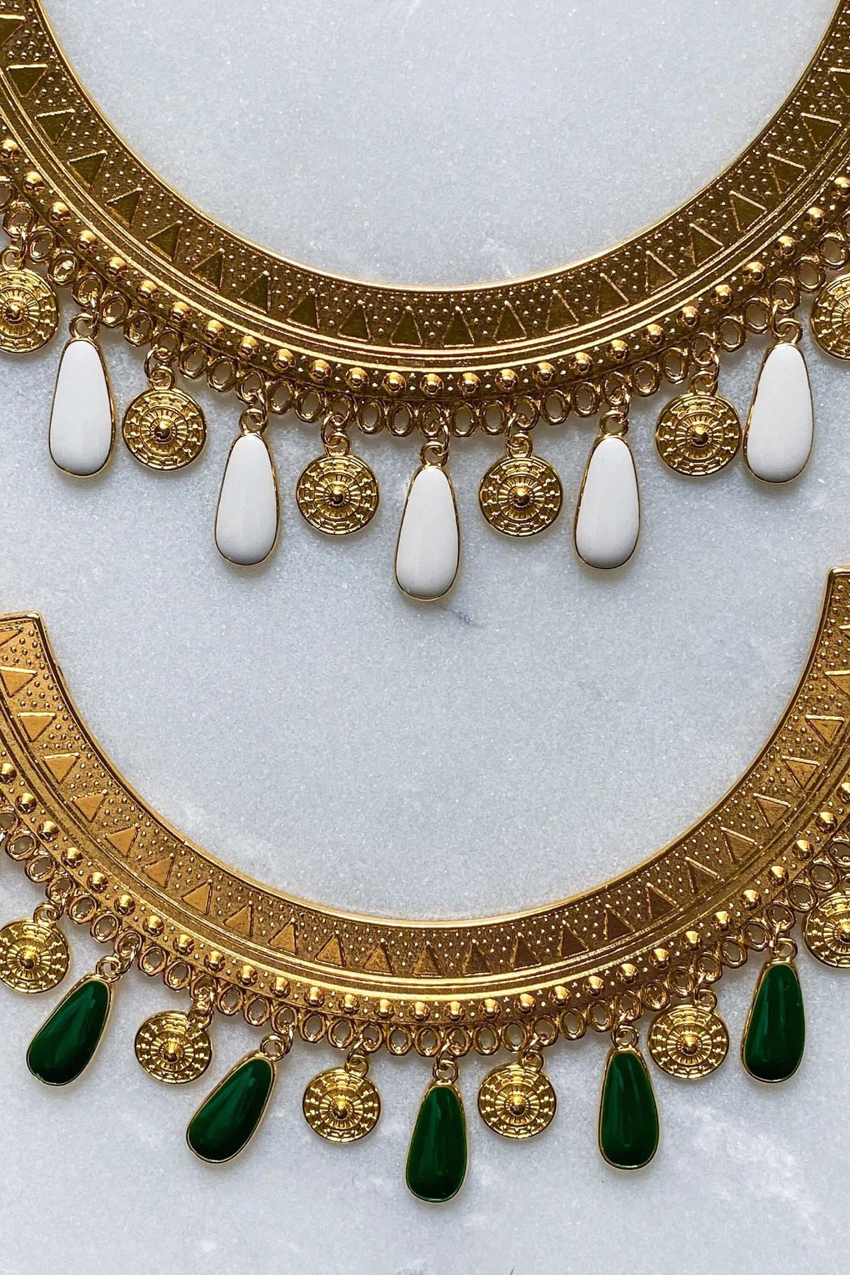 Boho chic necklace with an ornate gold-tone patterned collar, dangling round medallions and white or green teardrop charms