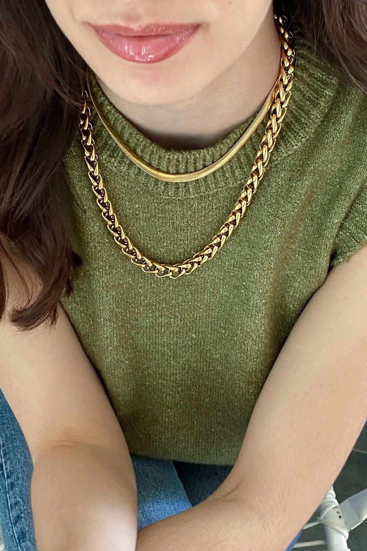 Chain Necklace in gold-tone metal with a flat snake chain design, worn as a delicate layered choker