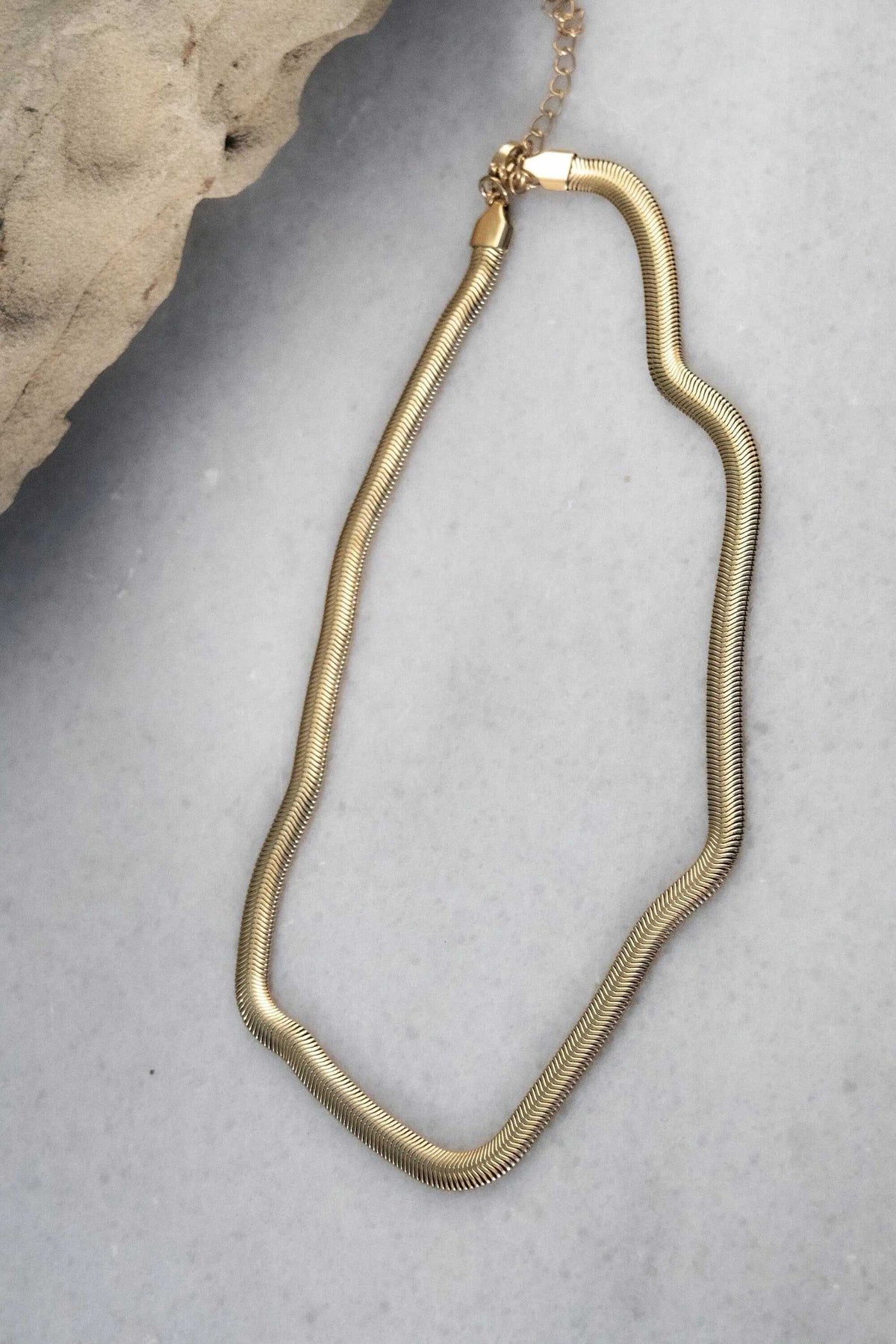 Chain Necklace in gold-toned metal with a smooth snake chain design and slender rounded silhouette