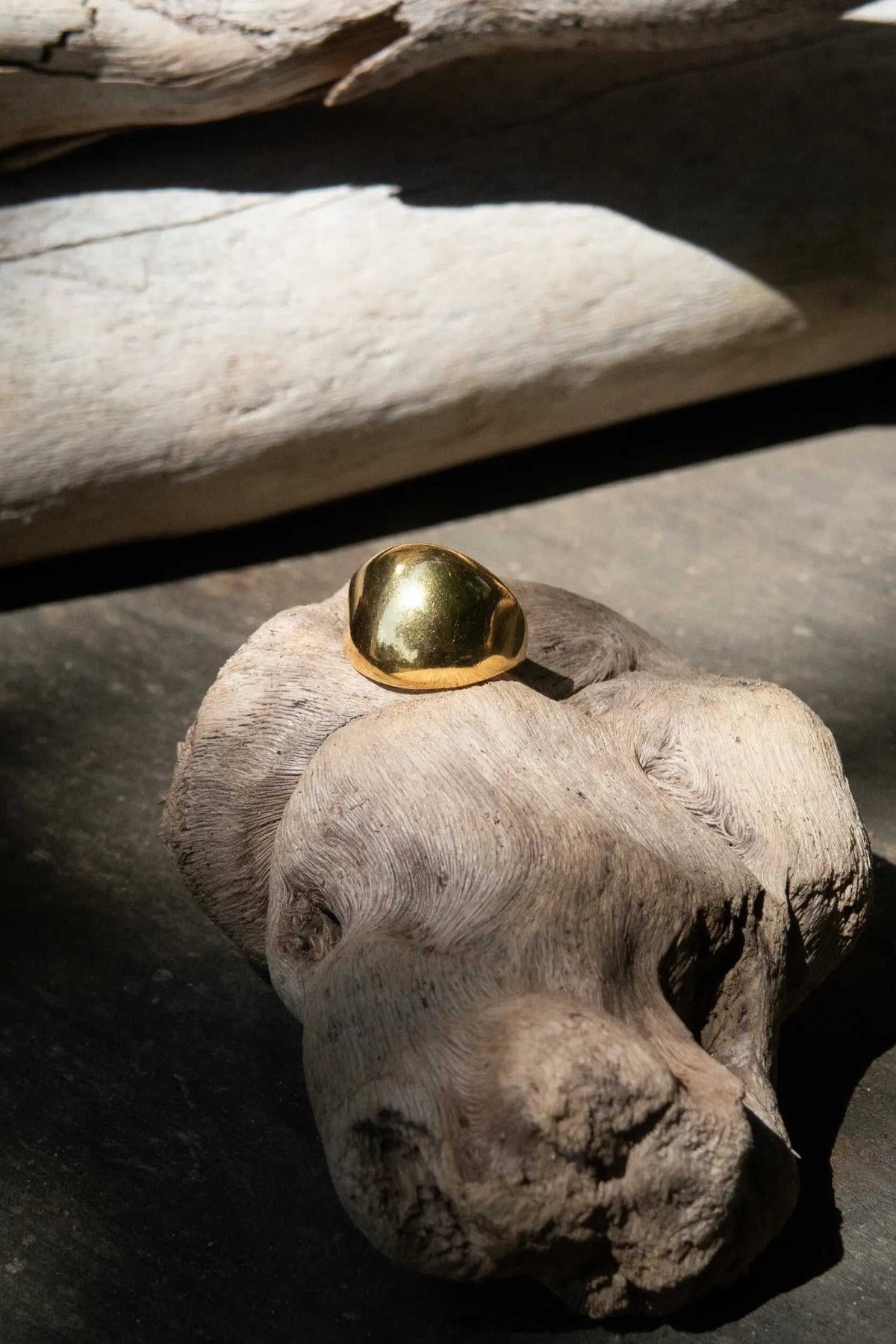 Chunky bold RING with a polished gold-tone finish, featuring a smooth, rounded dome on an adjustable band