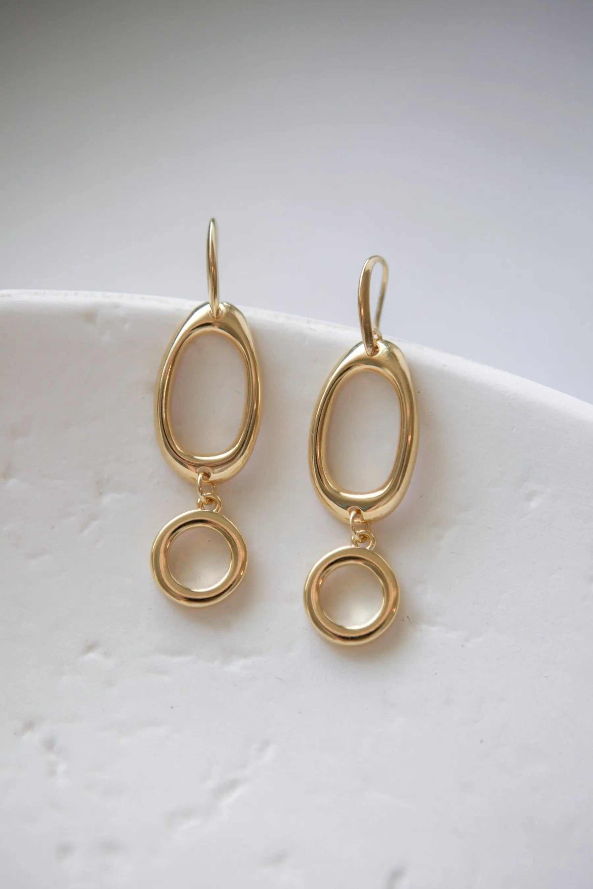 Classic Oval Earrings in gold-tone brass with double oval hoops and dangling circular charms