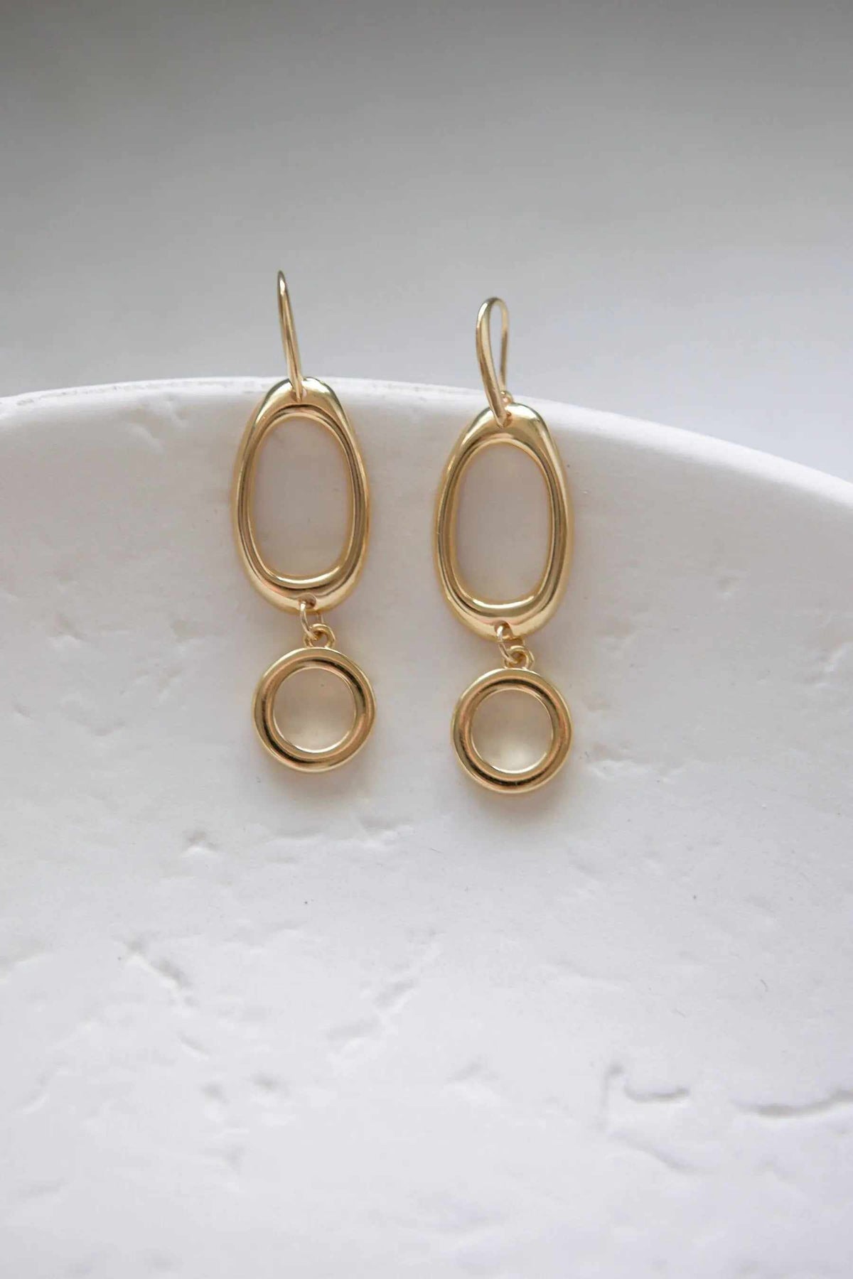 Classic Oval Earrings in gold-tone metal, with elongated open oval drops and smaller circular pendants