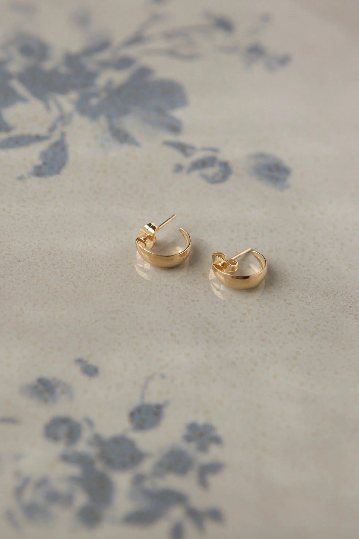 Crescent moon Hoops in polished gold-tone metal, small curved earrings with slim posts and open crescent shapes