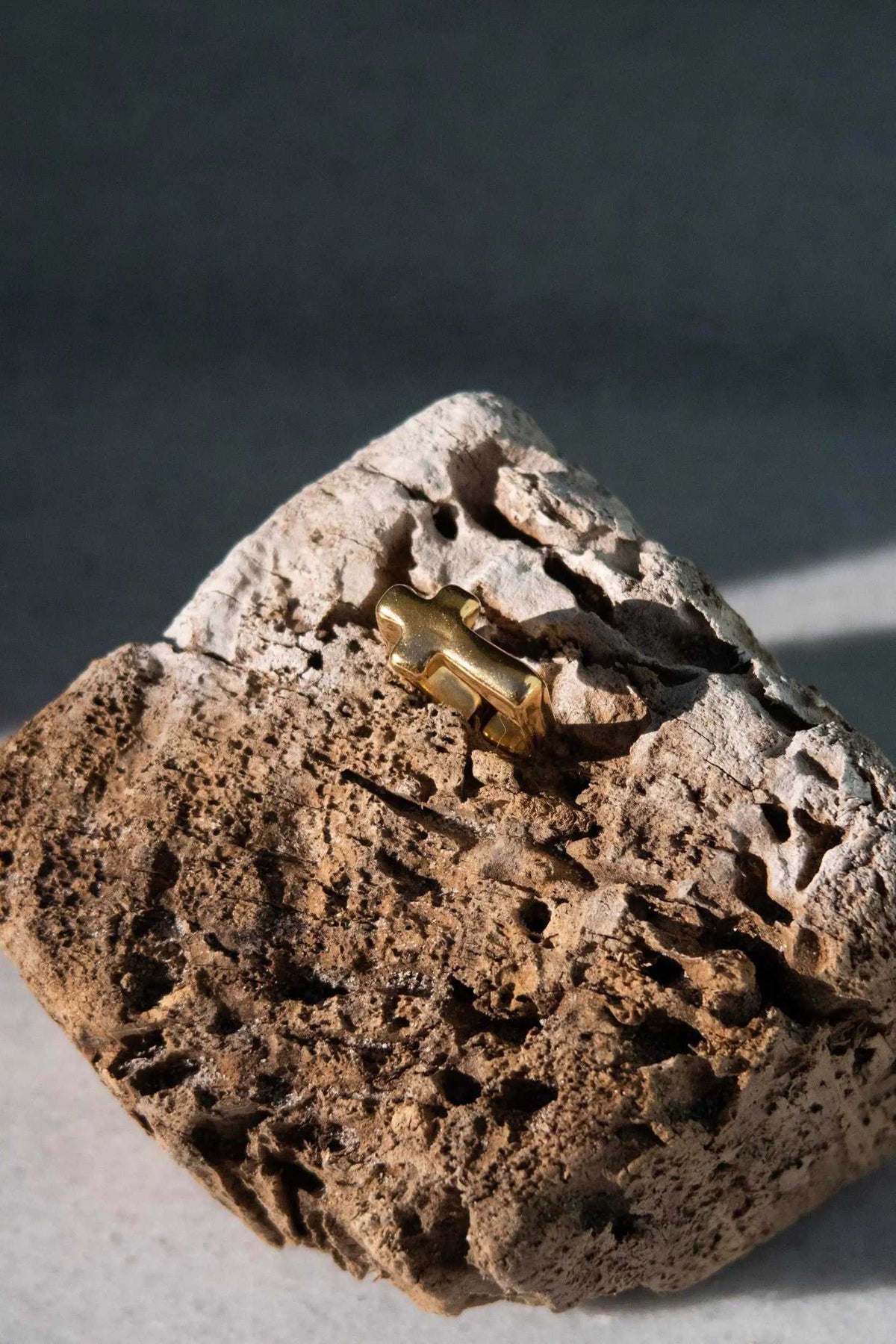 Cross RING in gold-tone metal with a sculpted cross motif and textured, rugged surface