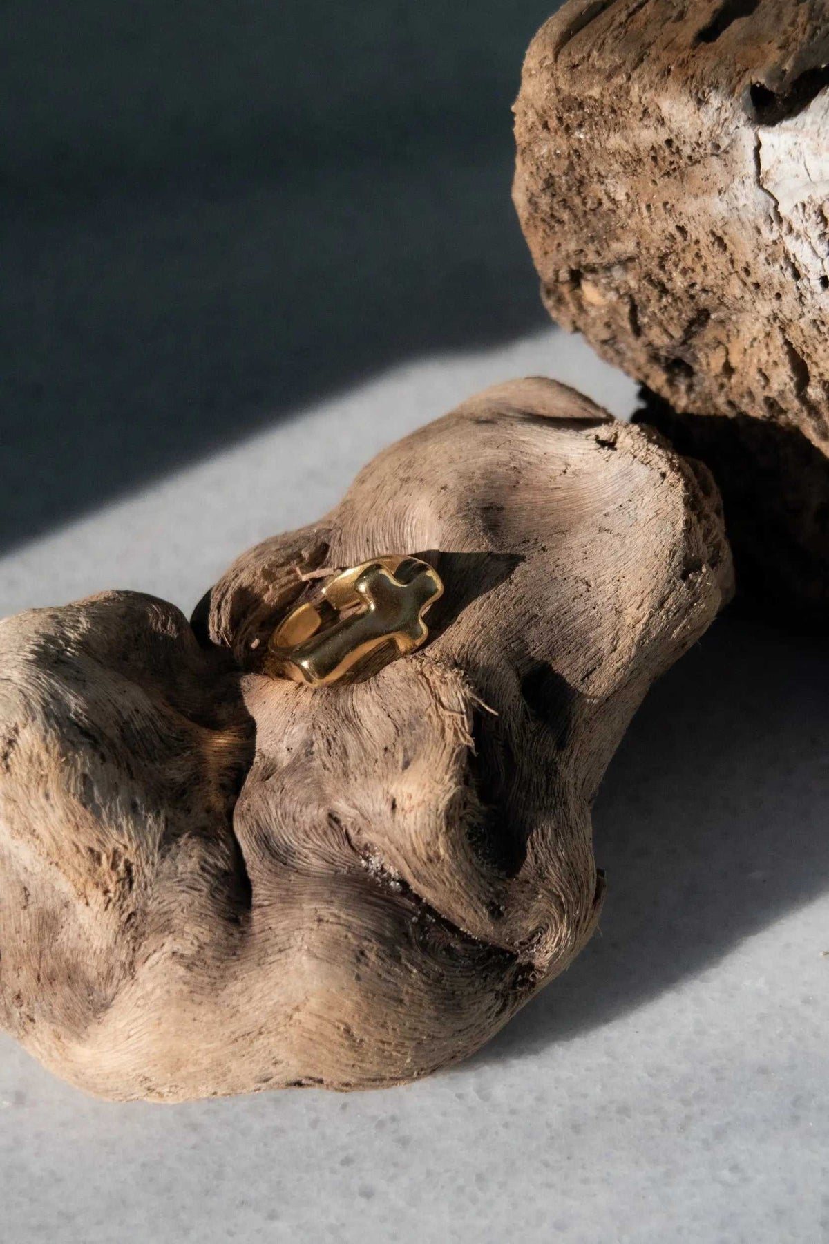 Cross RING in polished gold-tone metal, featuring a sculptural cross-shaped band with a raised profile
