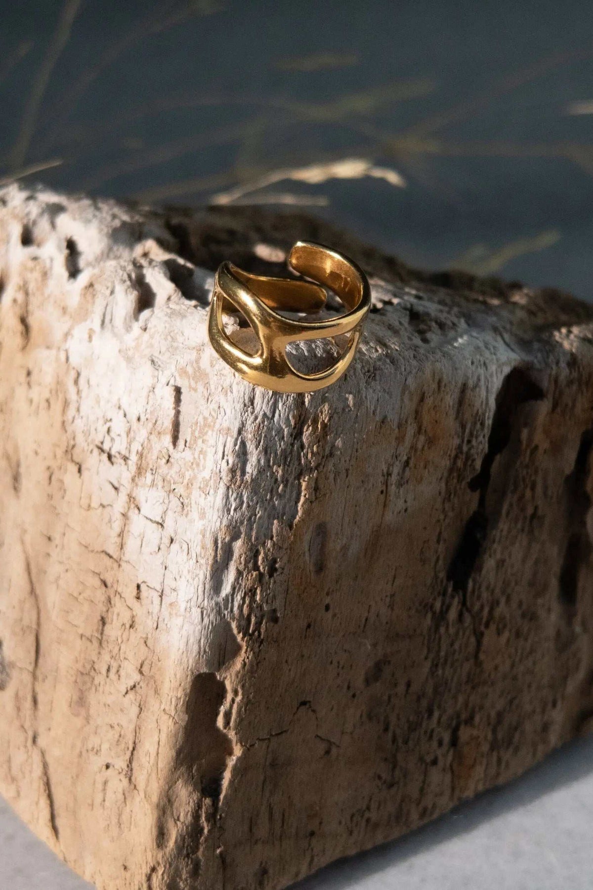 Deformed Organic RING, a gold-toned adjustable band with an irregular sculptural shape and open cutout details