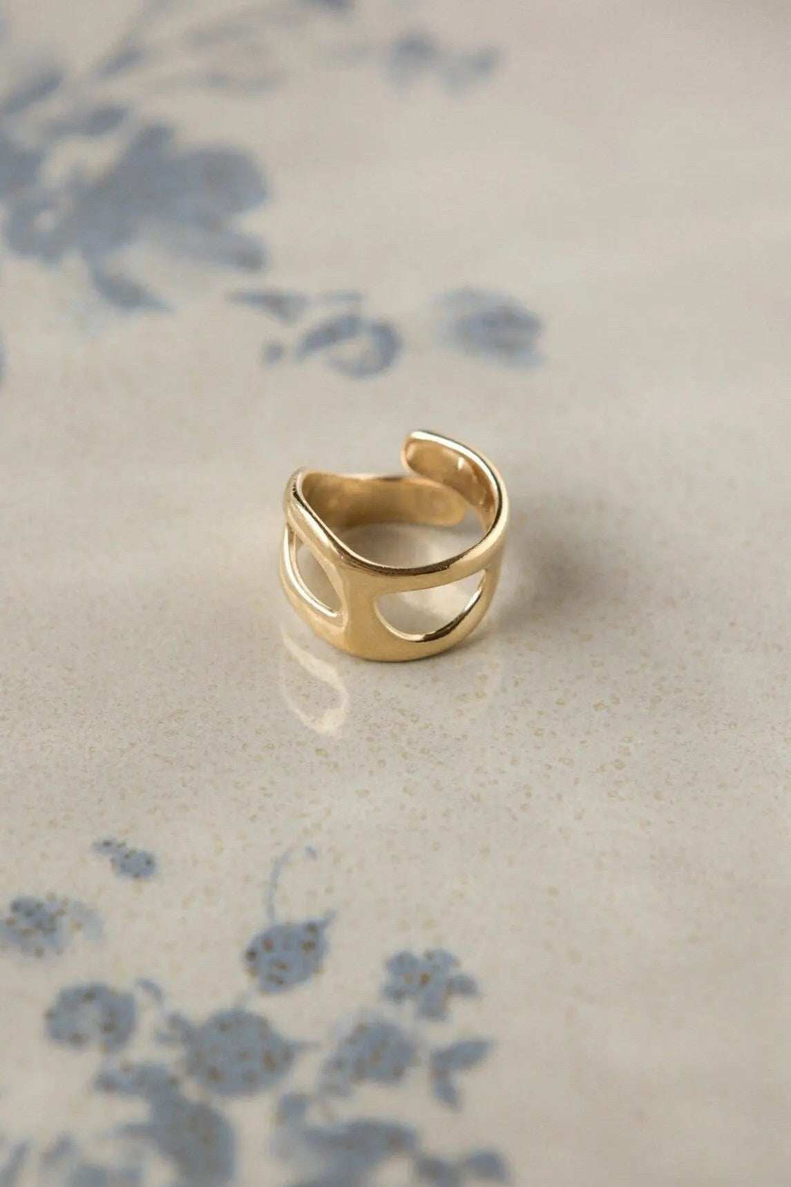 Deformed Organic RING, polished gold-tone adjustable band with an open, sculptural shape and irregular cutouts