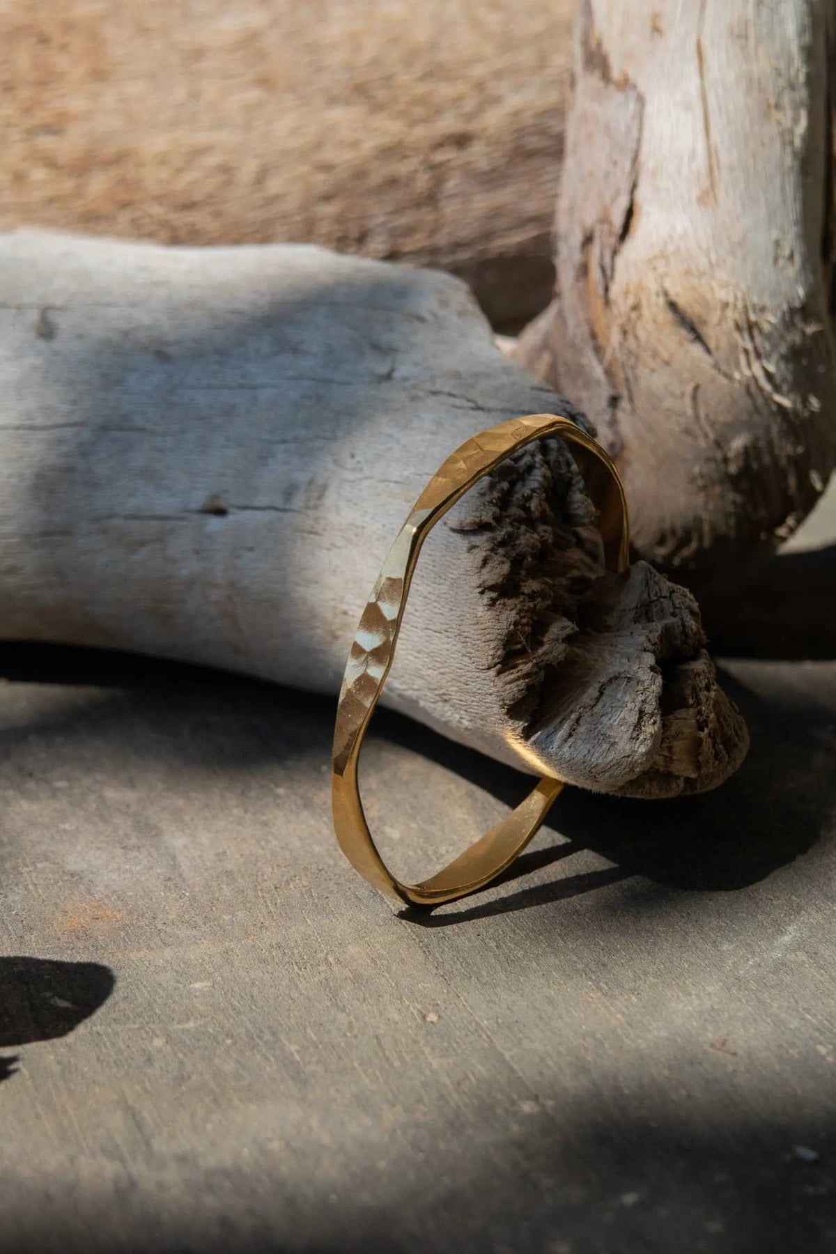 Delicate Hammered Bracelet in warm gold, a slim open cuff with uneven contours and a textured hammered finish