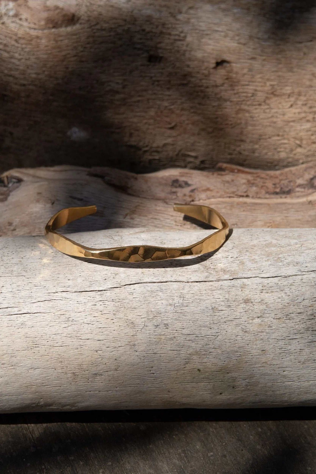 Delicate Hammered Bracelet in gold-tone metal with a slim open cuff and an uneven, hammered surface