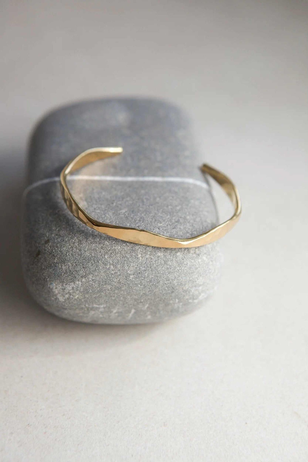 Delicate Hammered Bracelet in gold-tone metal with an open cuff design and subtly uneven, textured band
