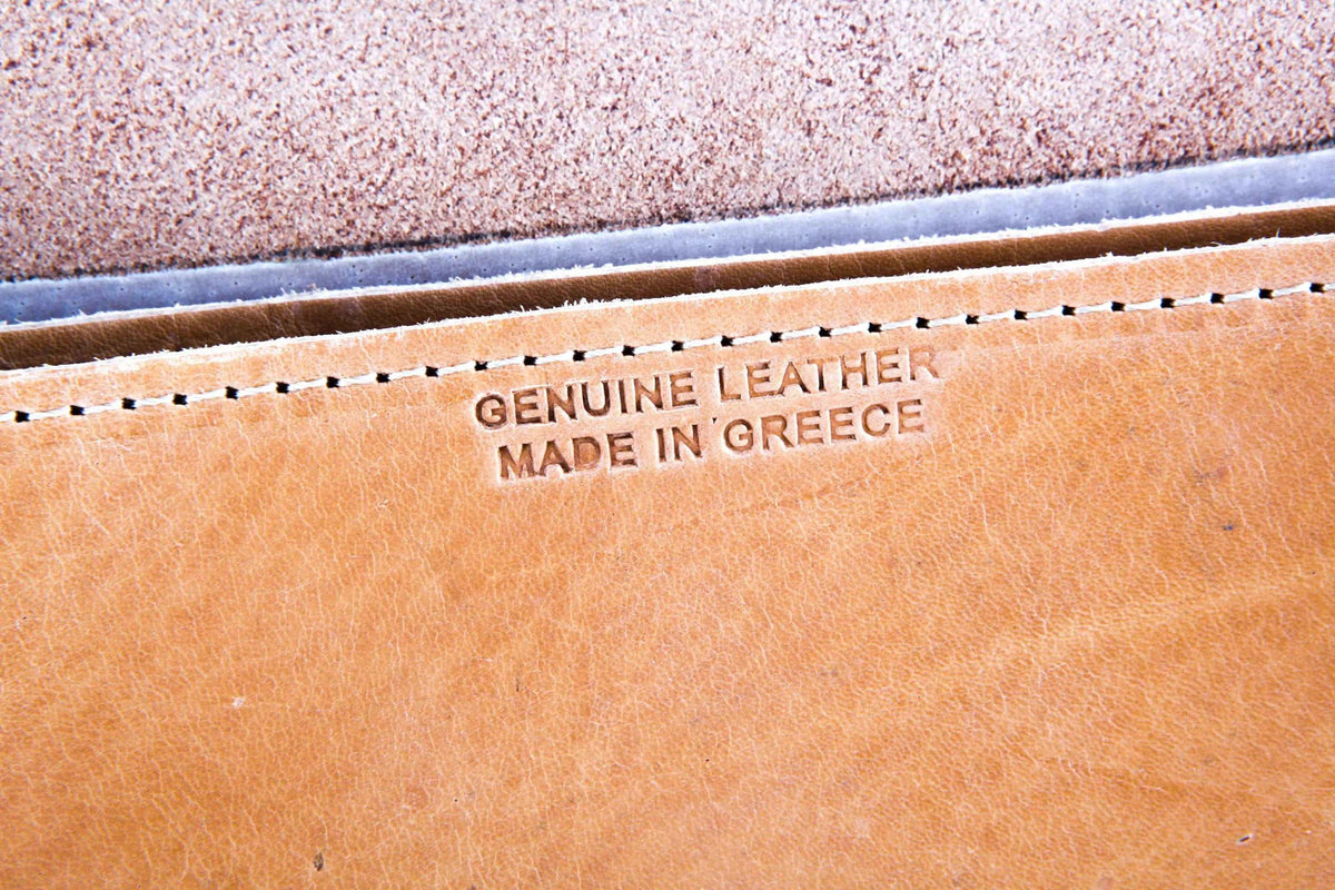 DIONE leather bag interior in natural tan full-grain leather, stamped “Genuine Leather Made in Greece” beneath stitched edge