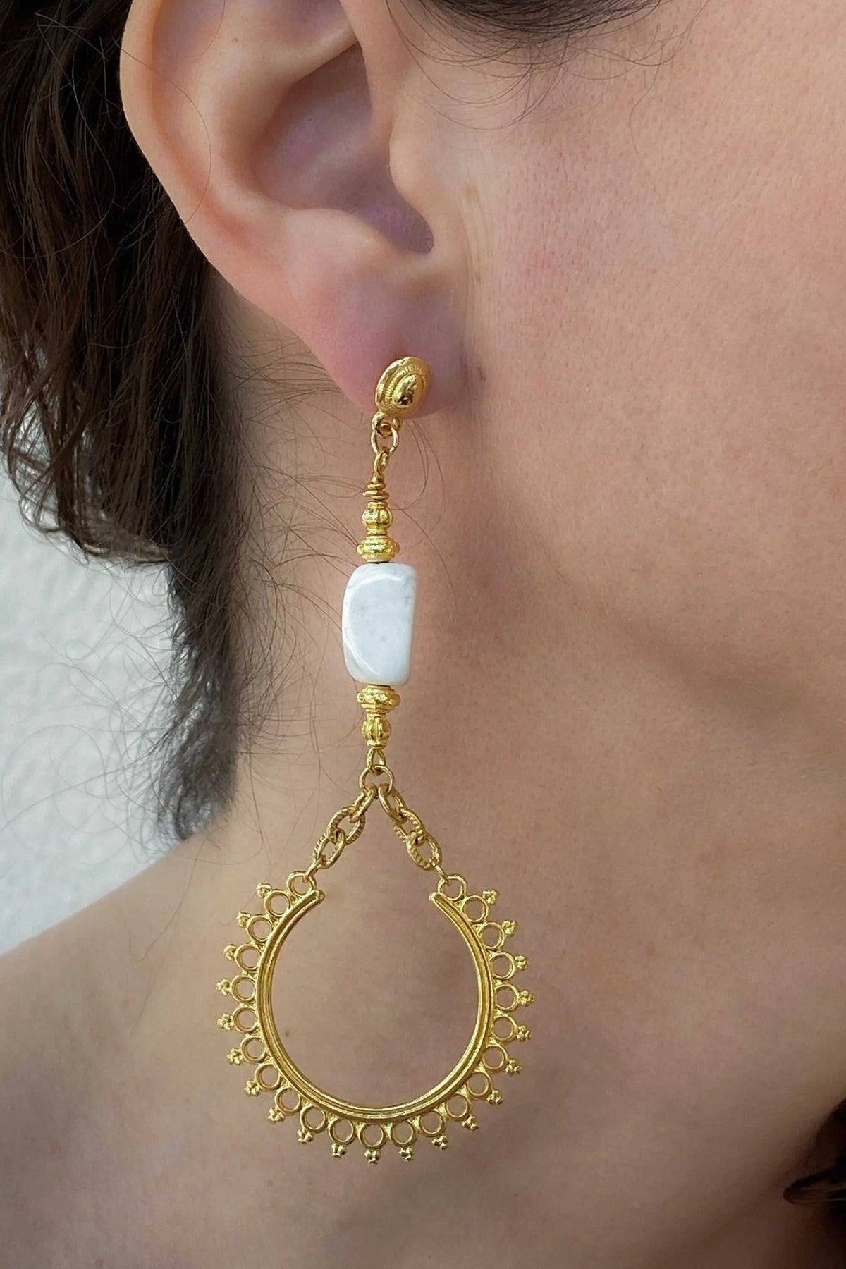 ÉRIS EARRINGS in gold-tone metal with a white rectangular stone and ornate dangling teardrop hoops