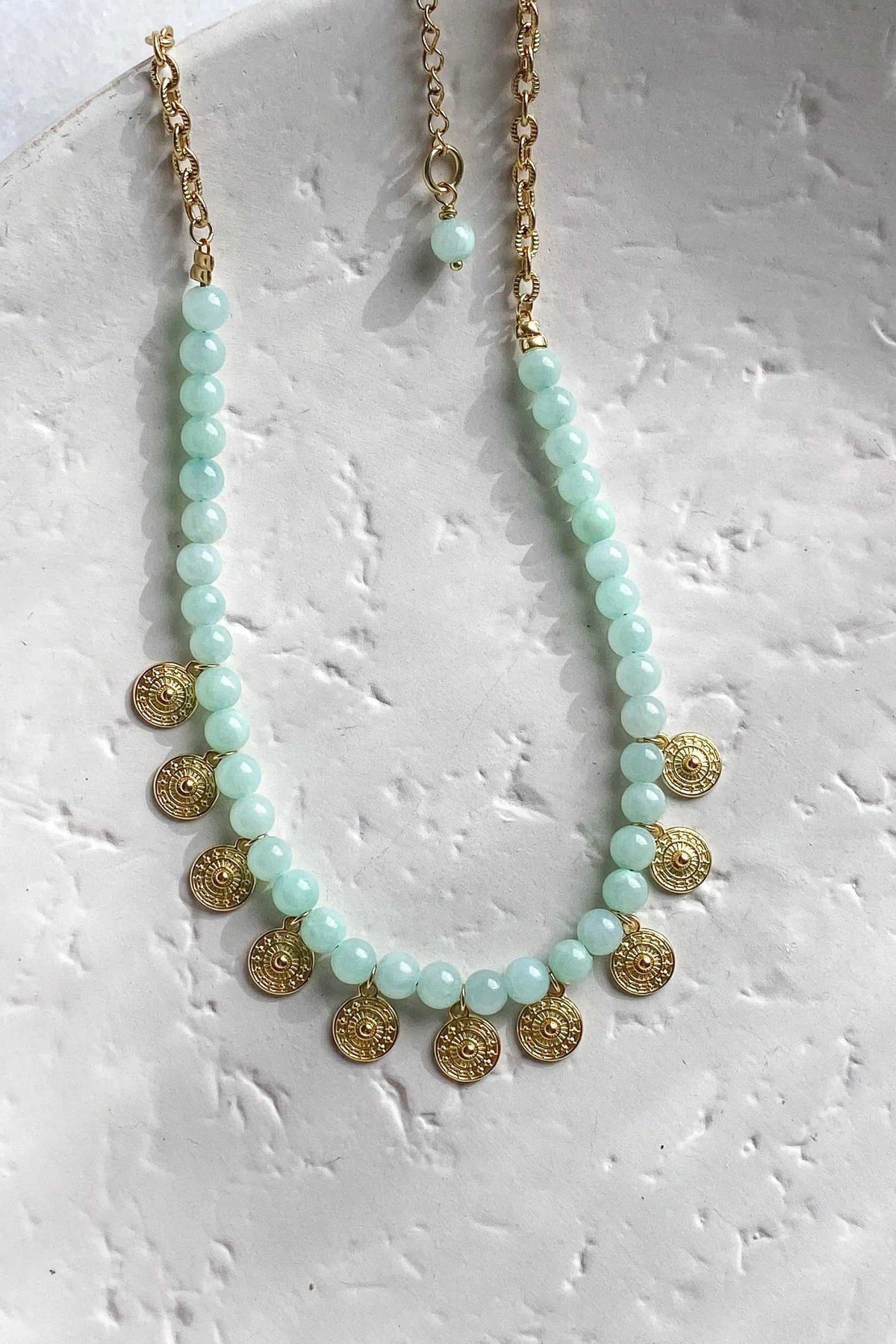 ERSA NECKLACE with pale aqua round gemstones, a gold-tone chain and small ornate round gold pendants