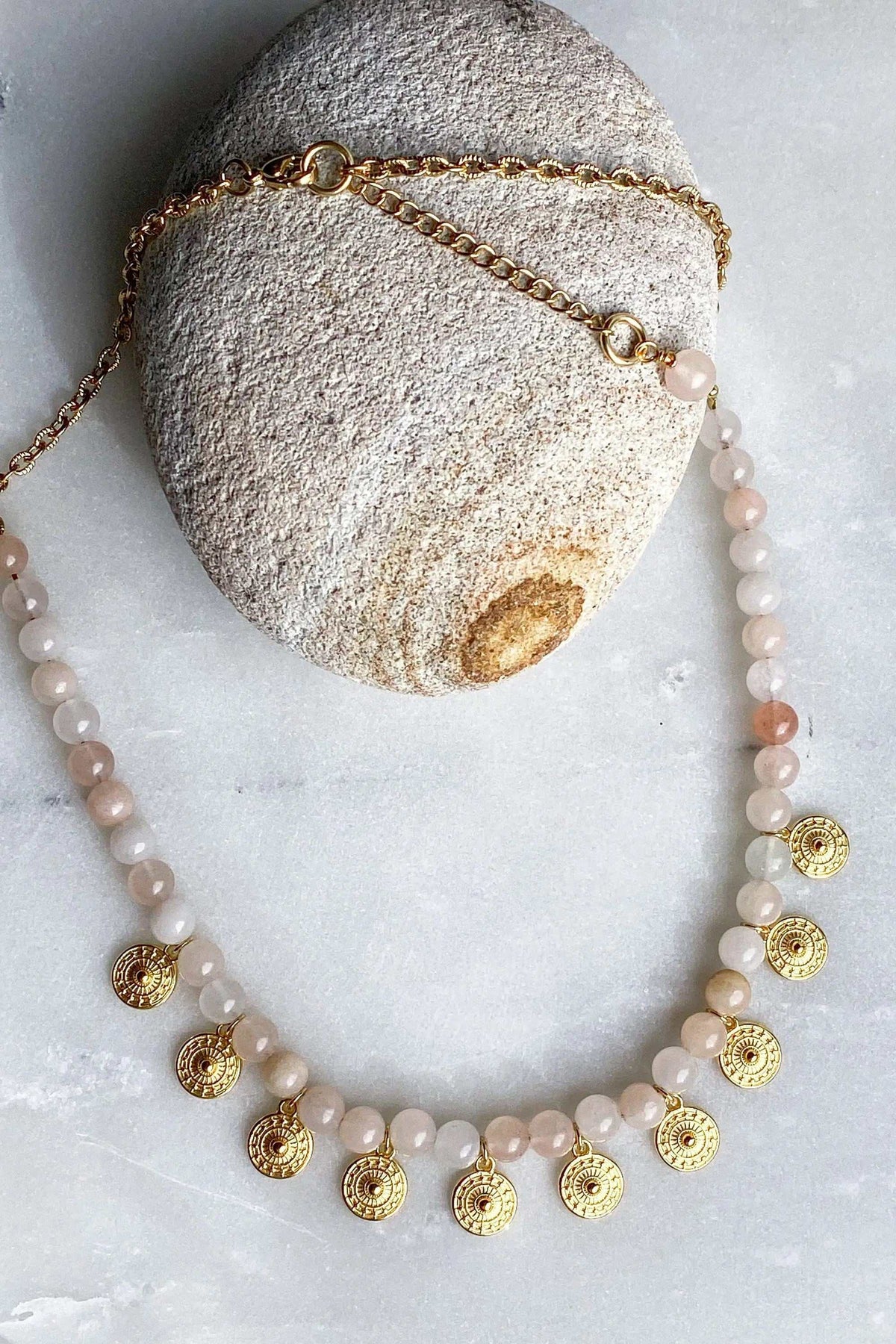ERSA NECKLACE with pale peach round beads, a gold-tone chain and ornate small gold-tone drop pendants