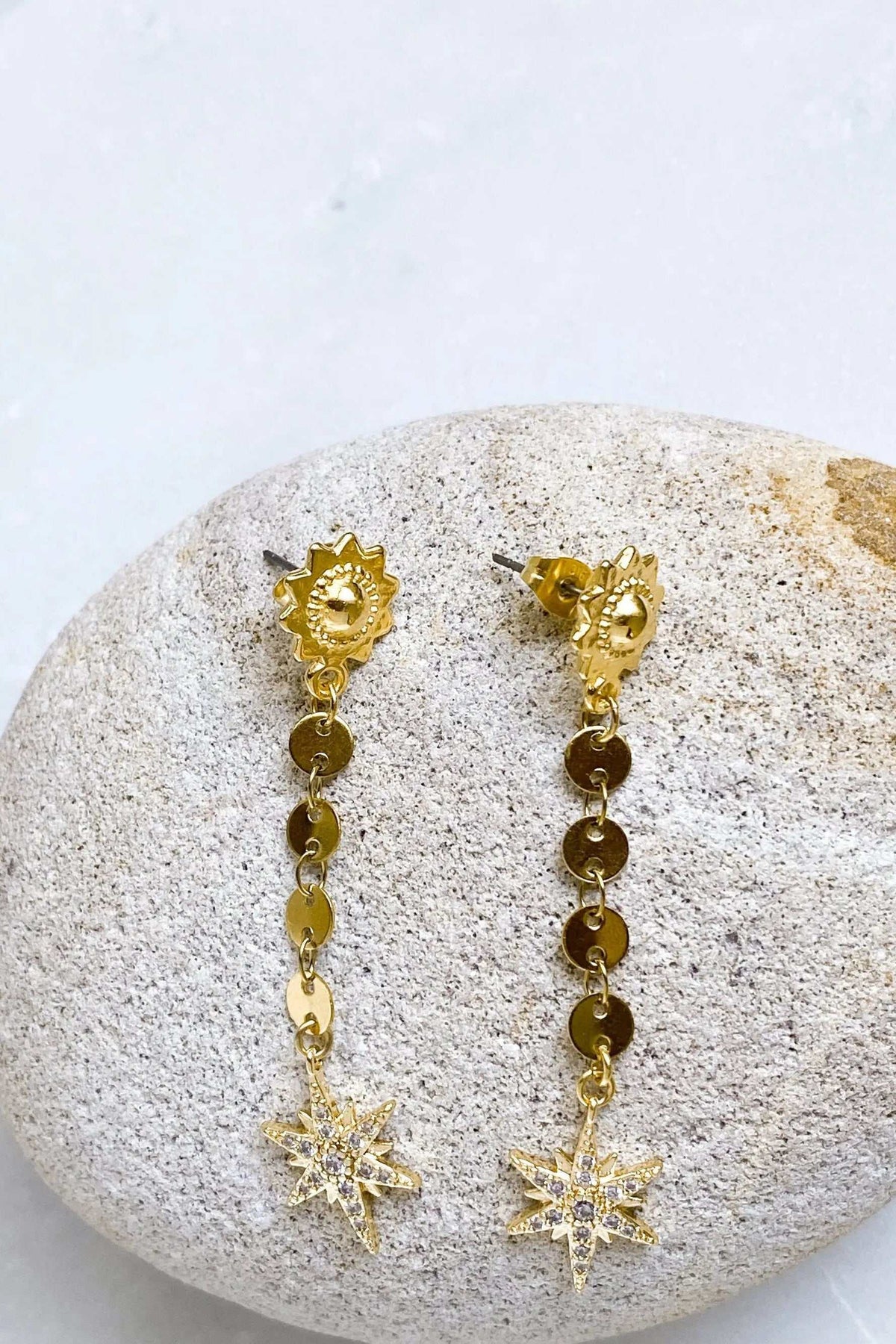 ESTRADE Earrings in gold-tone metal with celestial sun motifs and long linked chains ending in starbursts