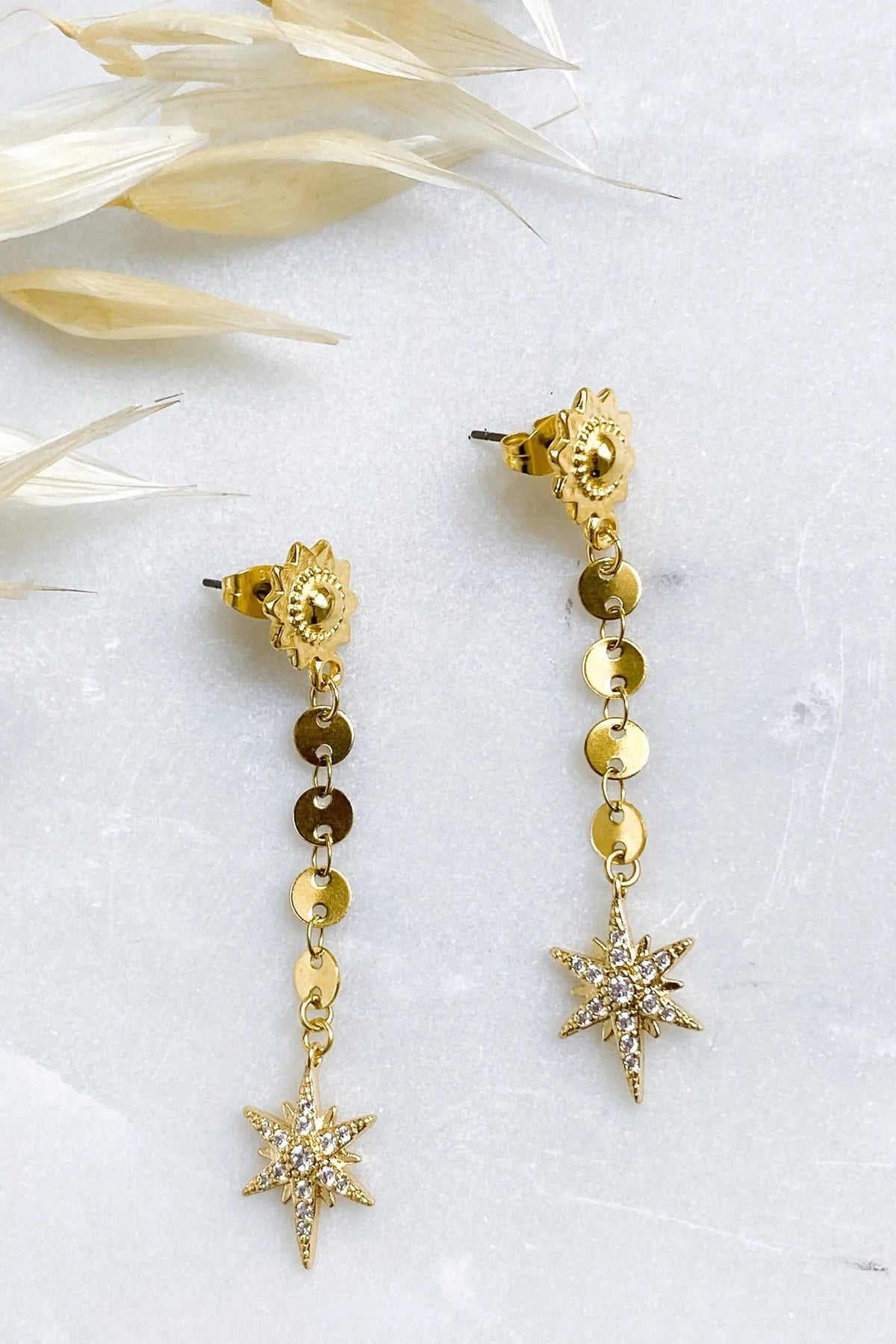 ESTRADE Earrings, gold-toned long chain earrings with ornate studs, linked discs, and starburst pendants
