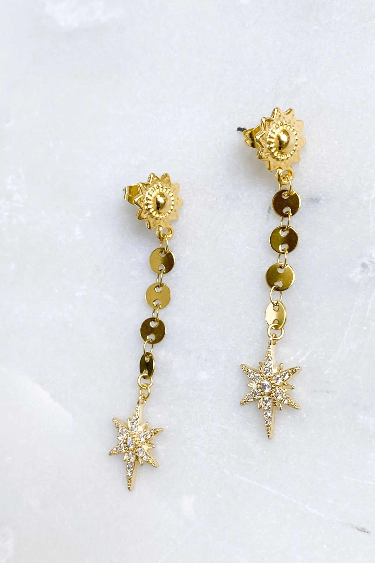 ESTRADE Earrings are gold-toned celestial drop earrings with floral stud tops, linked disc chains and sparkling starburst charms.