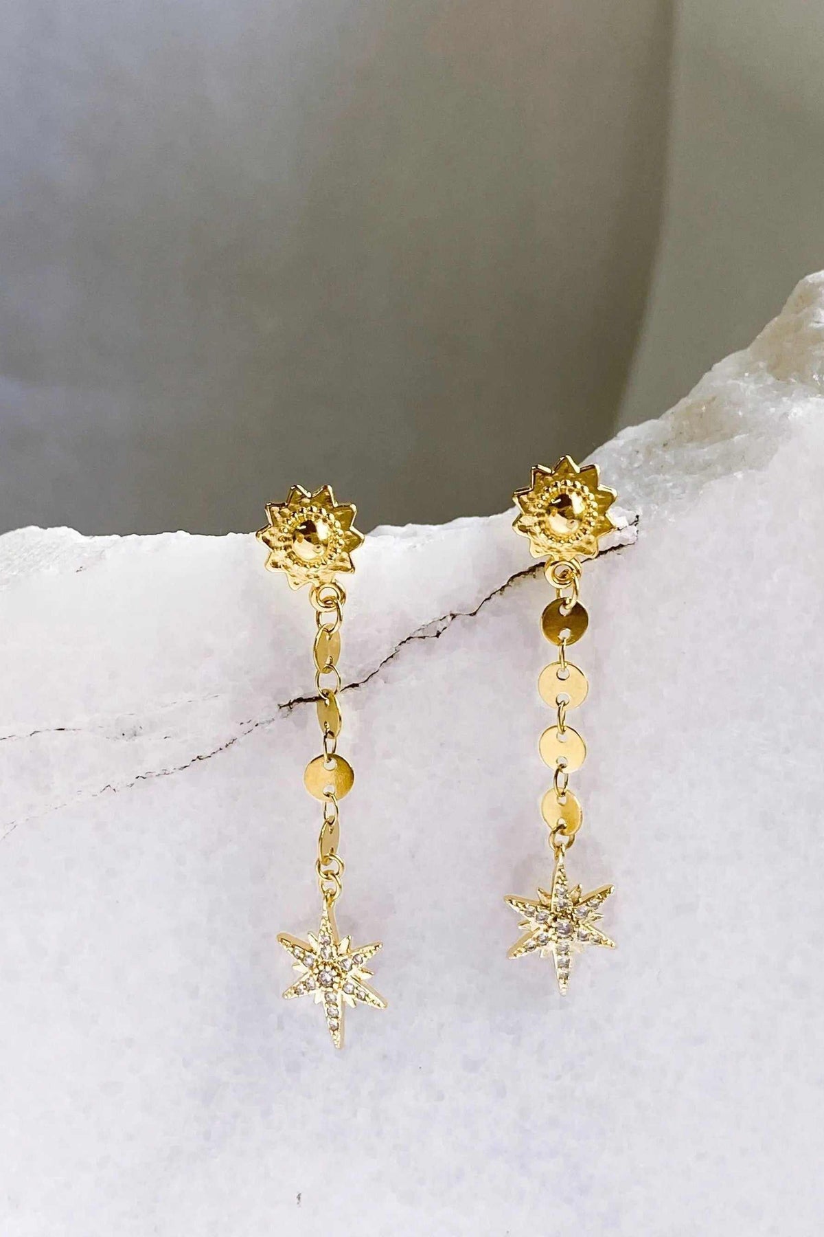 ESTRADE Earrings in gold-tone metal with linked chains, sunburst studs, and sparkling star-shaped drops