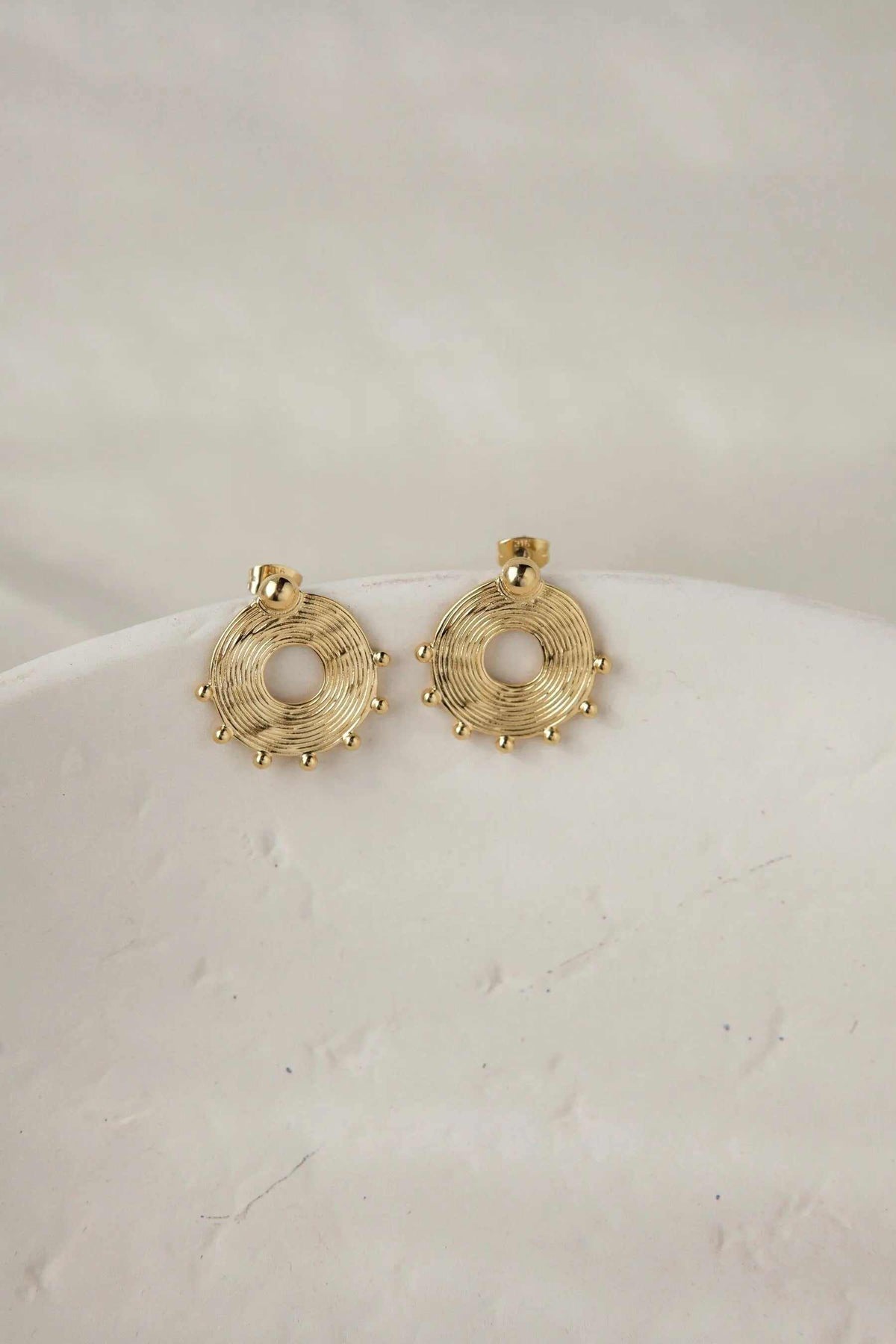Ethnic round Earrings in gold-tone metal with concentric circular wirework, open centers, and small bead accents
