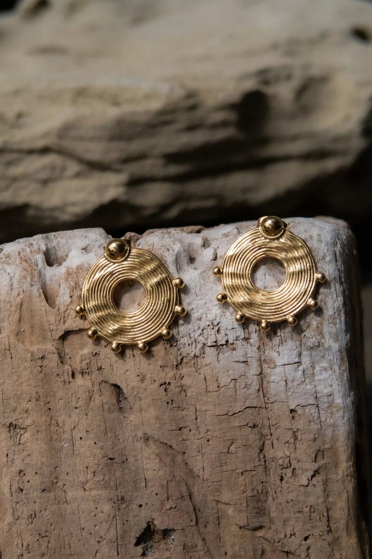 Ethnic round Earrings in gold-tone metal, with concentric ridges, open centers and small bead accents around each edge