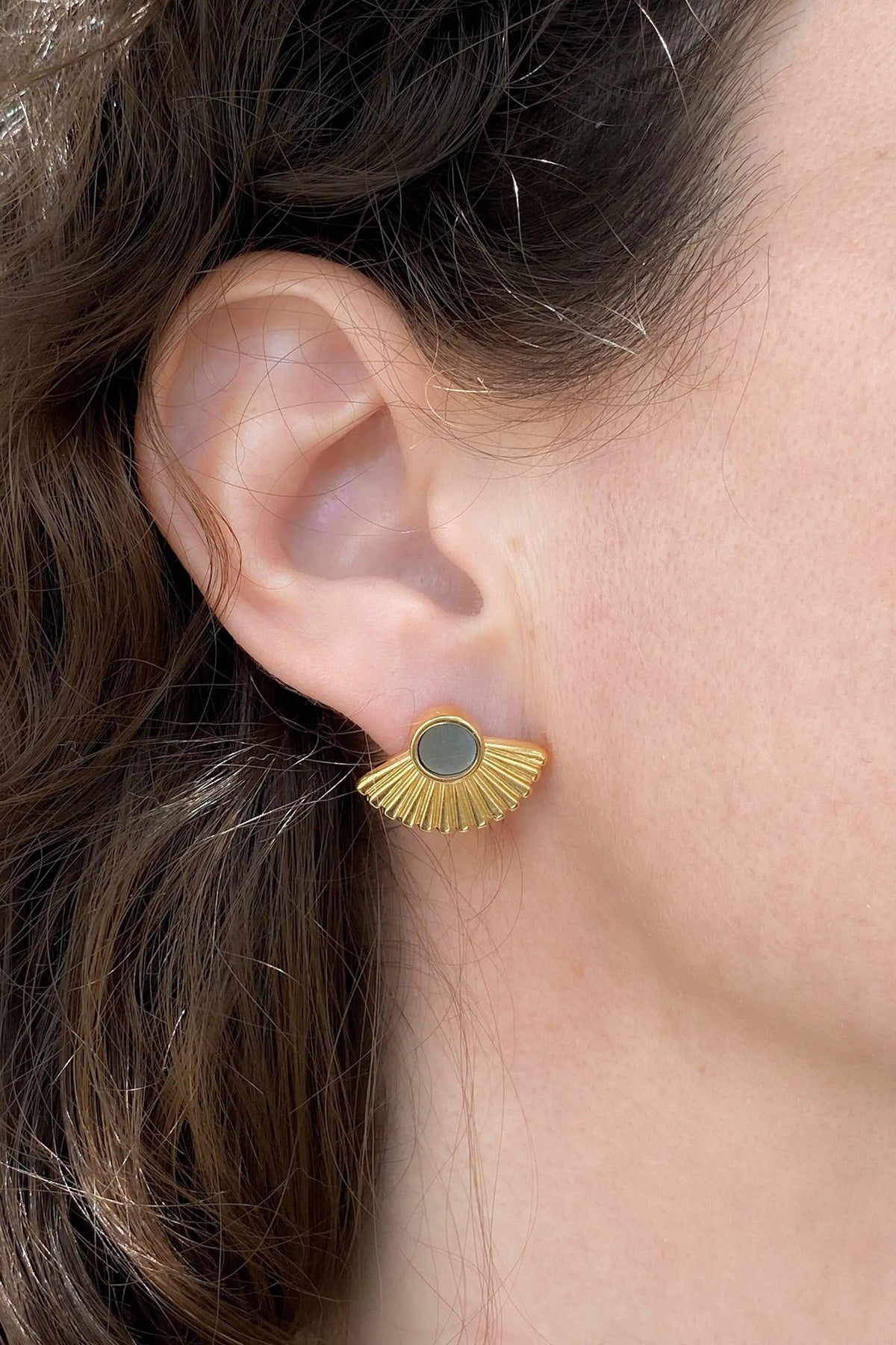 Ethnic stud earrings in gold-tone metal with a dark grey round center and fan-shaped radiating rays