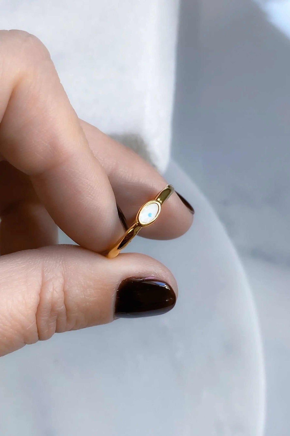 EYE Evil eye ring in gold-tone metal with a small oval white and blue eye detail on a slim band