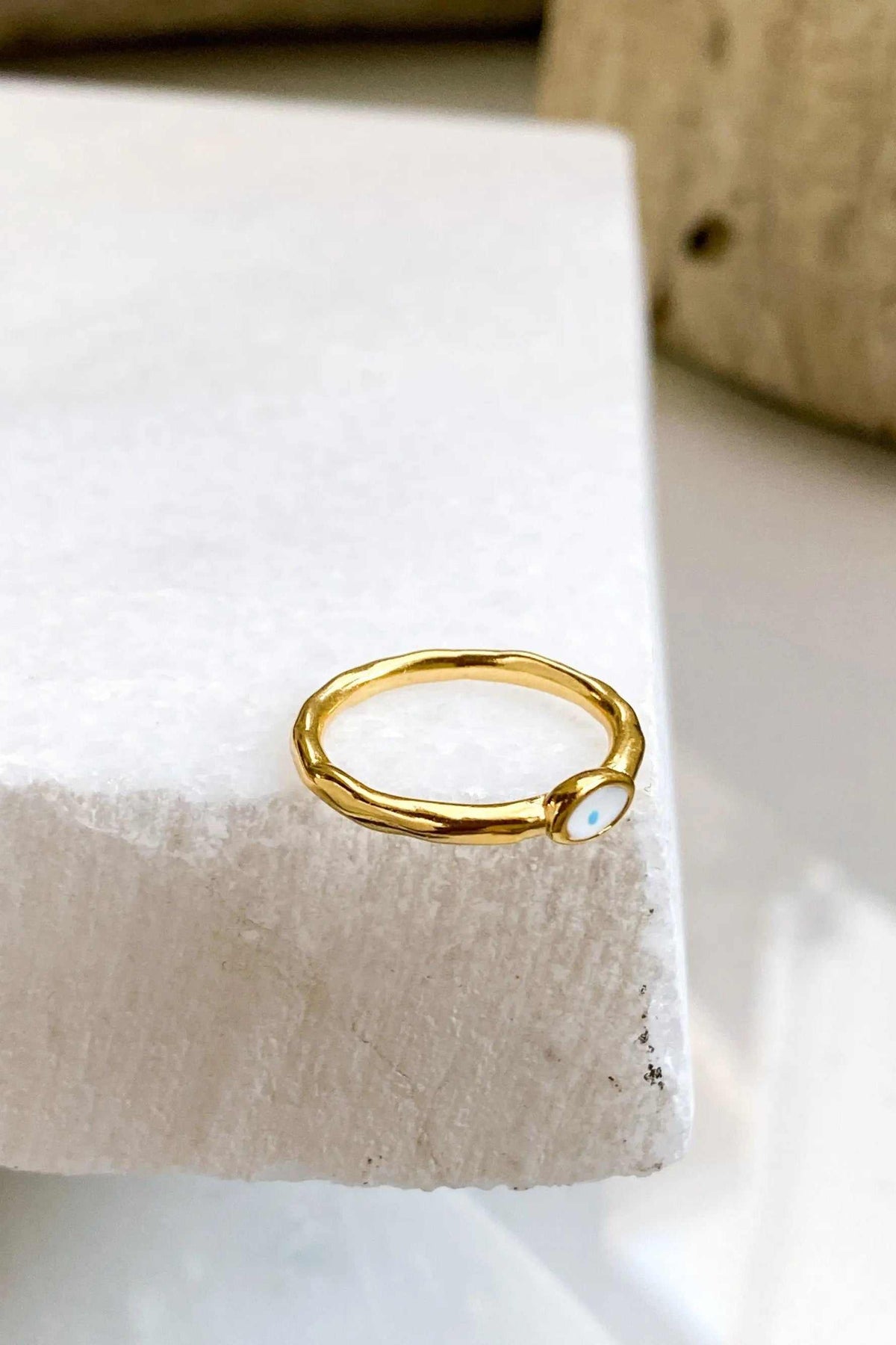 EYE Evil eye ring in polished gold-tone metal with a slender irregular band and small oval white eye detail