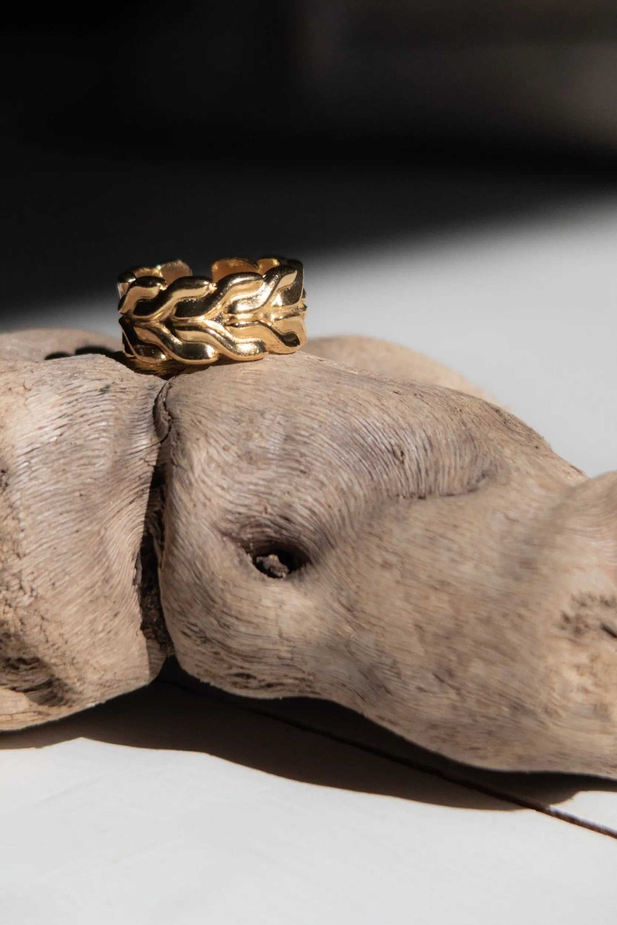 Foxtail chain ring in gold-tone metal, featuring a wide interwoven chain pattern and polished raised links.