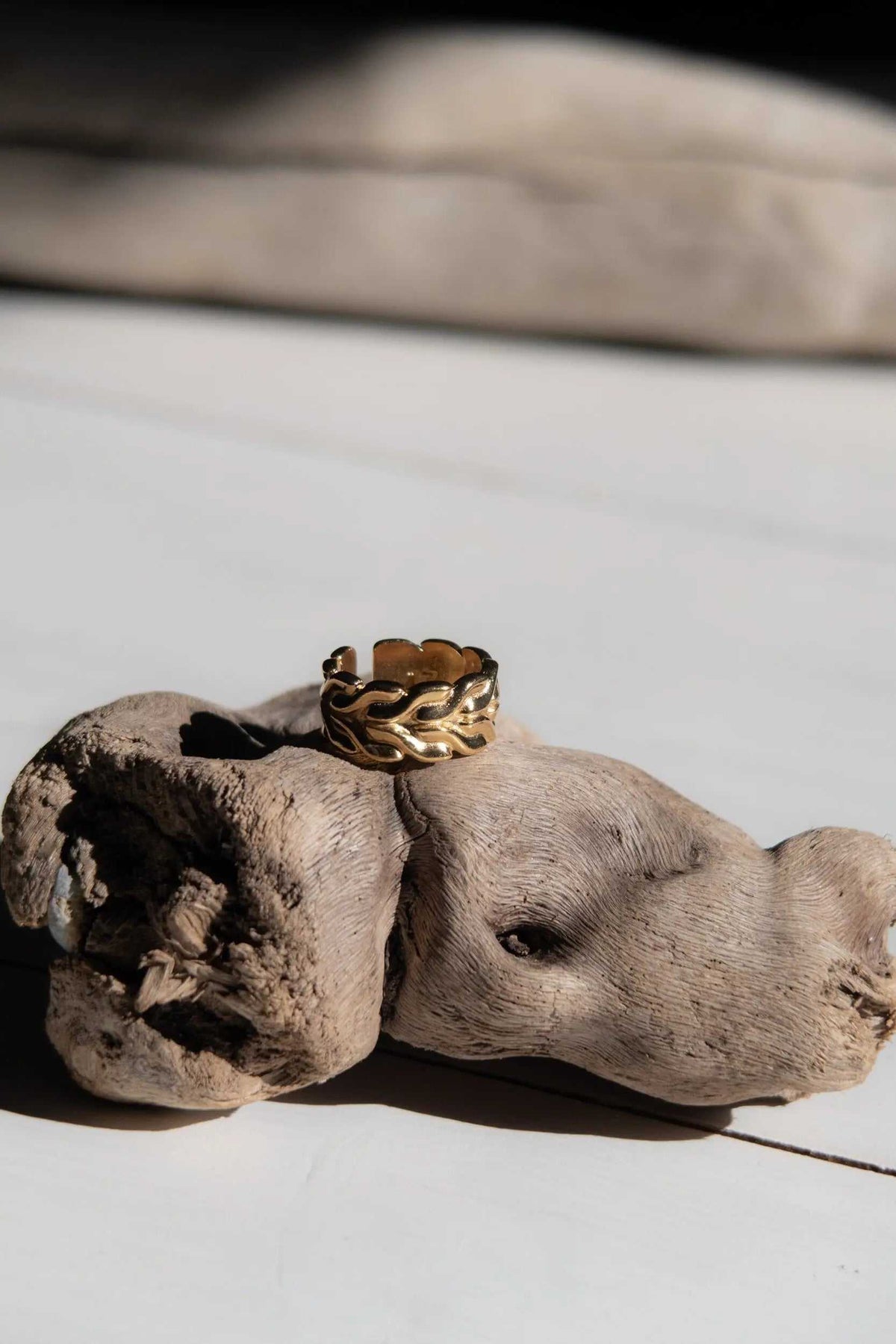 Foxtail chain ring in gold-tone metal with a textured woven chain pattern and adjustable open band