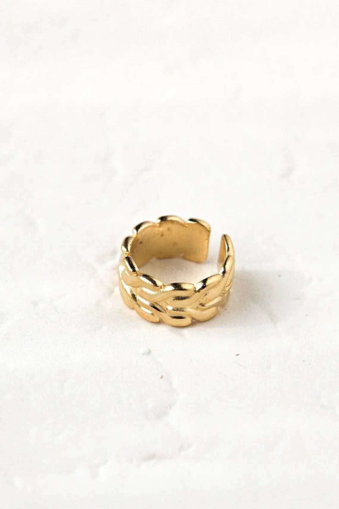 Foxtail chain ring in gold-tone metal, featuring a chunky woven chain design and an adjustable open band