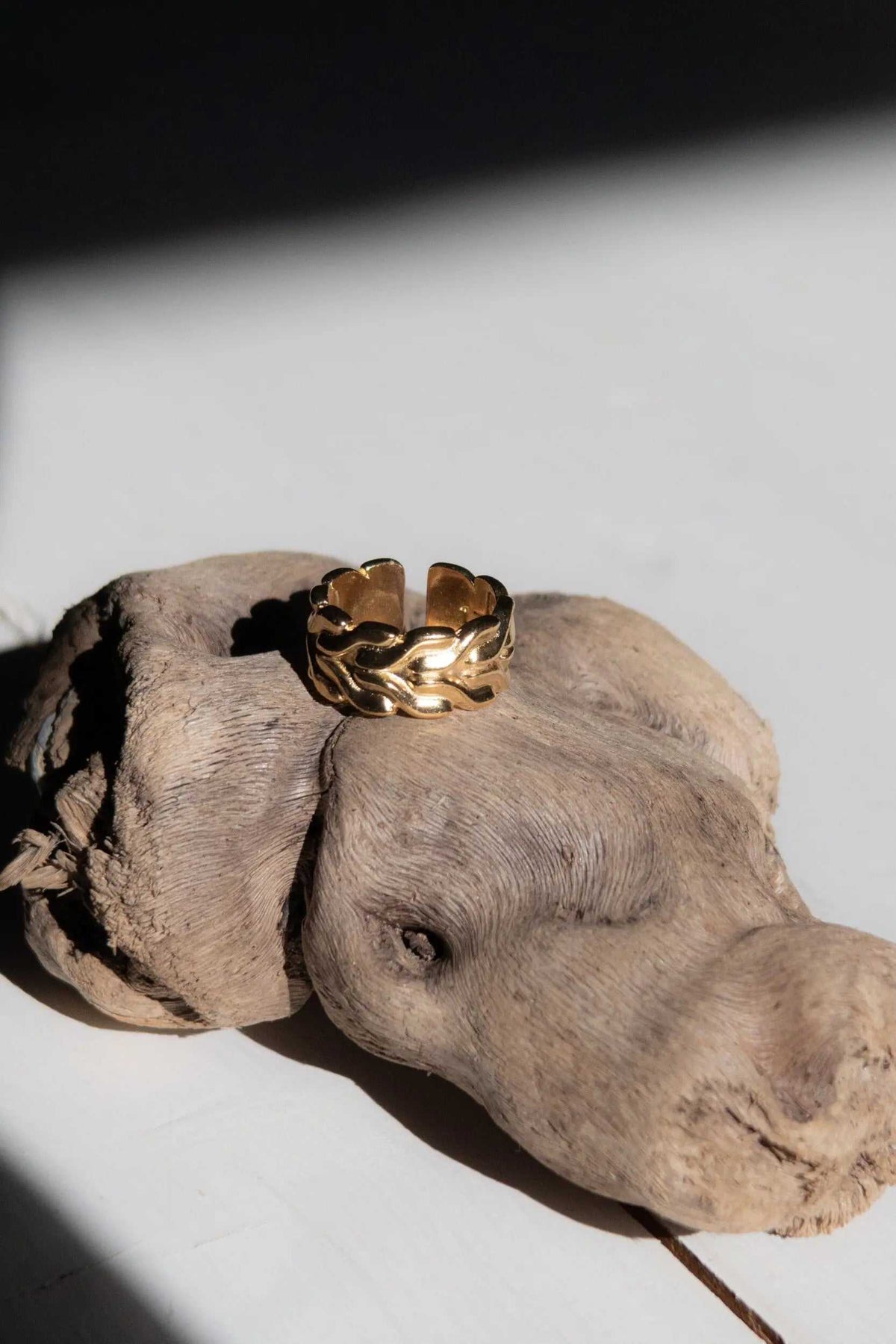 Foxtail chain ring in gold-tone metal, featuring a wide woven chain pattern and an adjustable open band